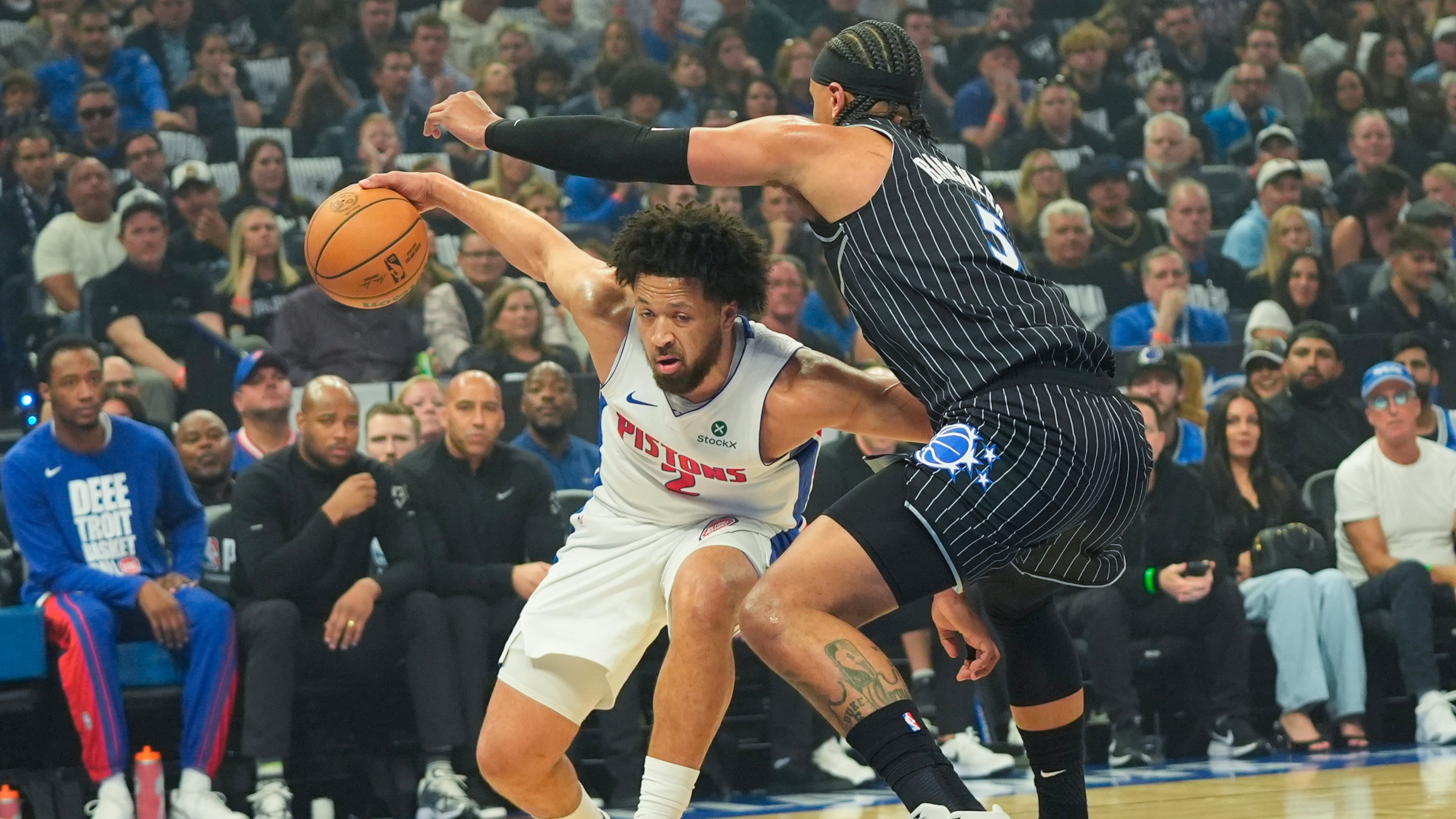 Detroit Pistons guard Cade Cunningham, left, tires to get past Orlando Magic forward Paolo Banchero, right, during the first half in Game 6 of a first-round NBA basketball playoffs series, Friday, May 1, 2026, in Orlando, Fla. (AP Photo/John Raoux)