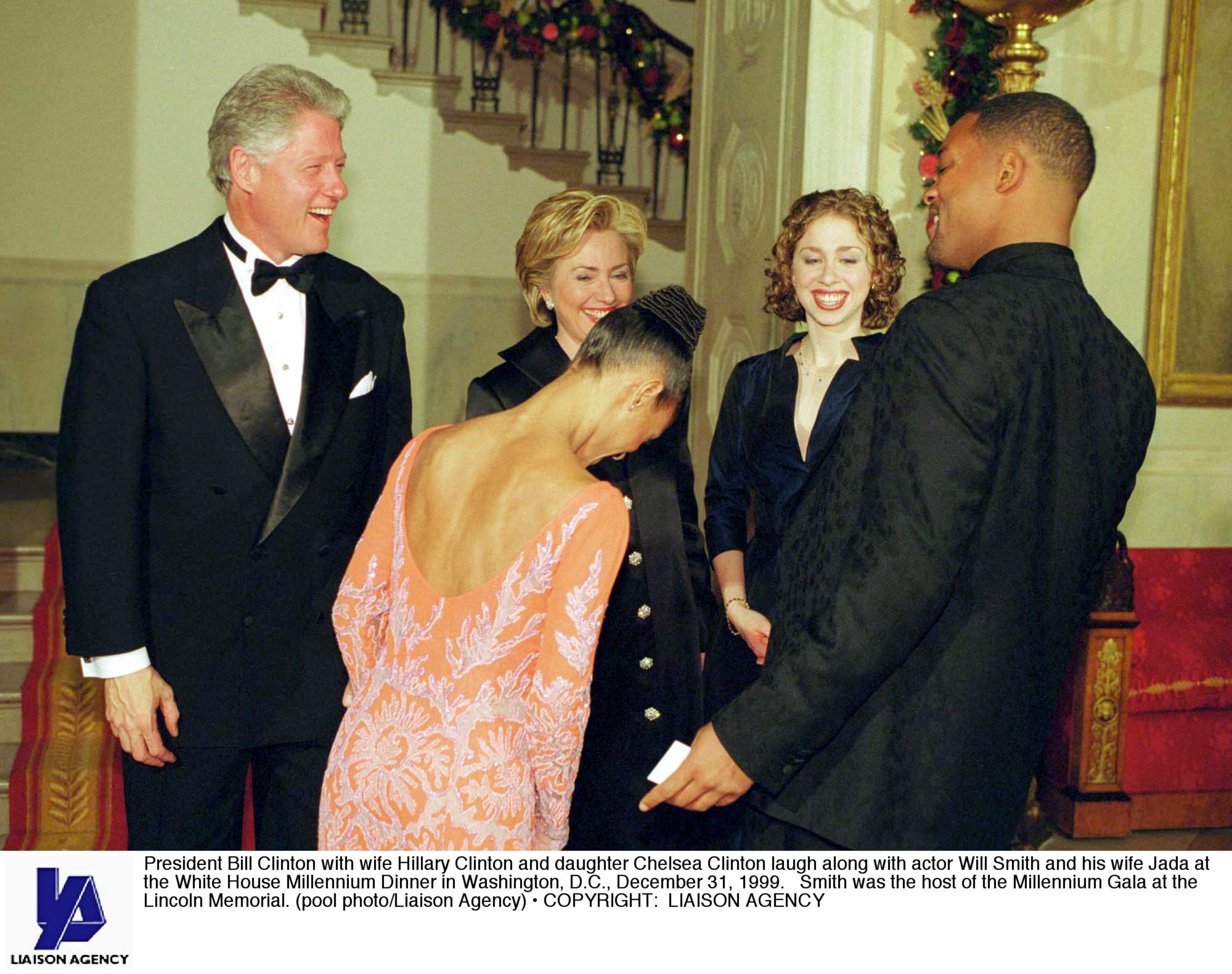 President Bill Clinton with wife Hillary Clinton and daughter Chelsea Clinton laugh along with actor Will Smith and his wife Jada at the White House Millennium Dinner in Washington, D.C., December 31, 1999. Smith was the host of the Millennium Gala at the Lincoln Memorial. (pool photo/Liaison Agency)