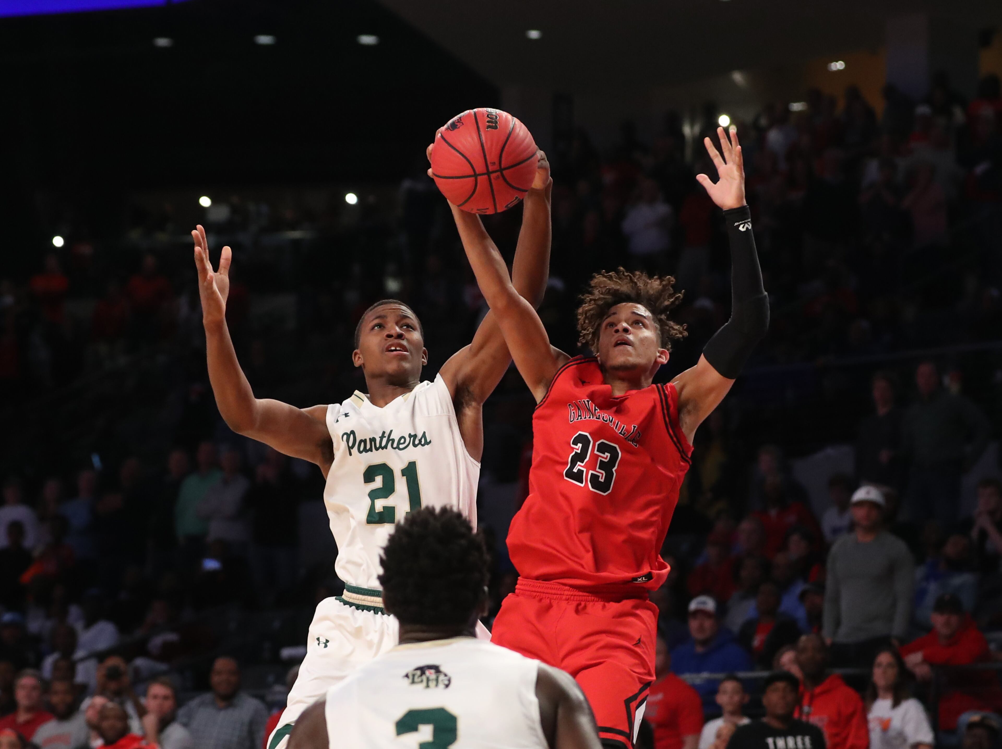 March 9, 2018 - Atlanta, Ga: Hughes guard Landers Nolley (21) fights for a rebound against Gainesville guard Rafael Rubel (23) during the second half of the GHSA Class AAAAAA Boys State Championship at McCamish Pavilion Friday, March 9, 2018, in Atlanta. Hughes won 85-78. PHOTO / JASON GETZ
