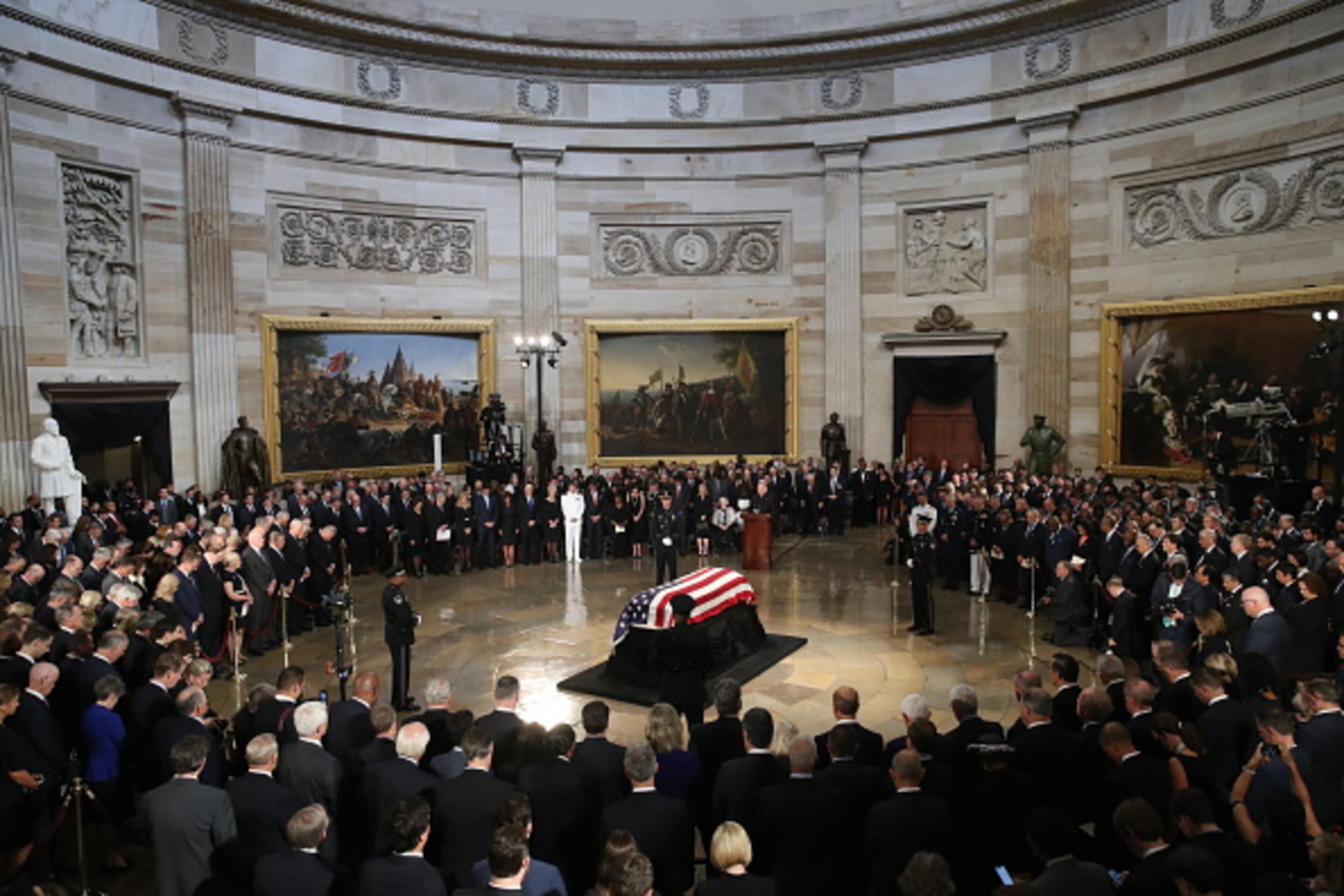 WASHINGTON, DC - AUGUST 31: The flag-draped casket of US Senator John McCain arrives inside the Rotunda of the U.S. Capitol, August 31, 2018 in Washington, DC. A Democrat who voted for Hillary Clinton, Farone said McCain did what was right. "He never took the easy way out, he knew actions speak louder than words and he never tweeted about it. He just got it done," she said. The late senator died August 25 at the age of 81 after a long battle with brain cancer. He will lie in state at the U.S. Capitol Friday, a rare honor bestowed on only 31 people in the past 166 years. Sen. McCain will be buried at his final resting place at the U.S. Naval Academy on Sunday. (Photo by Drew Angerer/Getty Images)