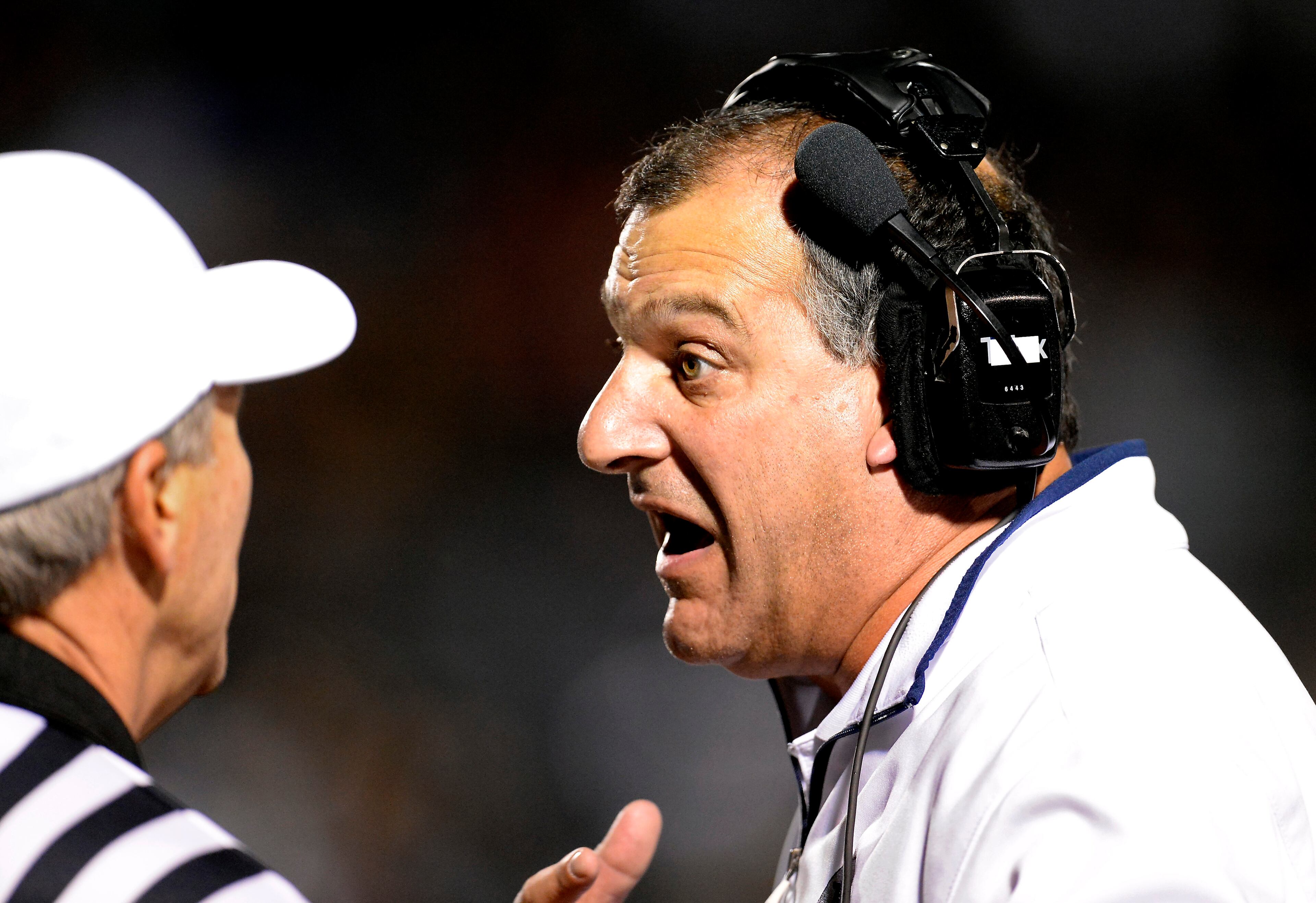 Norcross coach Keith Maloof, right, makes a point to a referee in the first half of their AAAAAA semifinal game against Colquitt County at Blue Devil Stadium on Friday, Dec. 6, 2013, in Norcross, Ga.