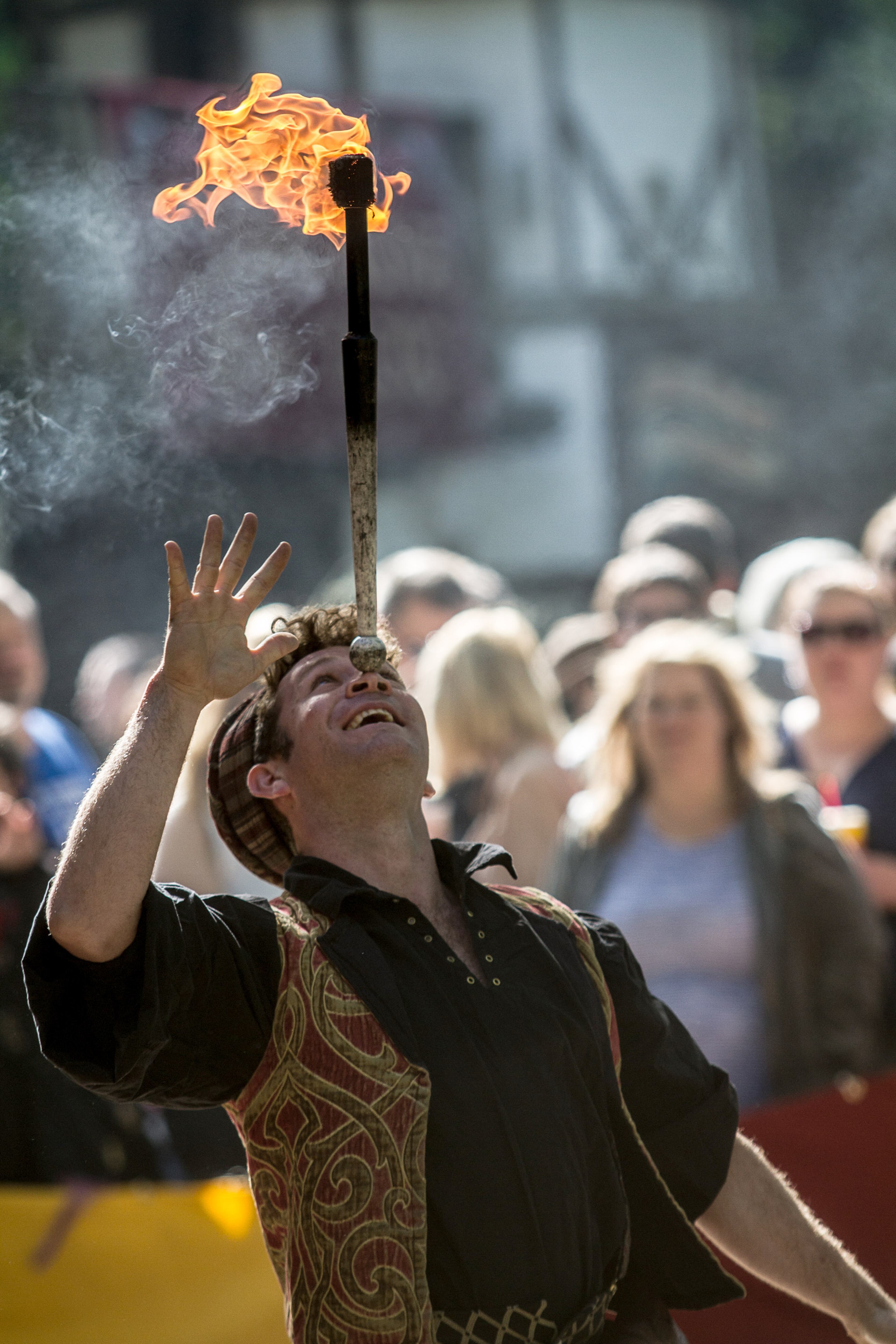 Geoff Marsh entertains the crowd by balancing a flaming baton on his forehead before the gates open on the first day of the Georgia Renaissance Festival in Fairburn, Ga. Saturday April 16, 2016. STEVE SCHAEFER / SPECIAL TO THE AJC