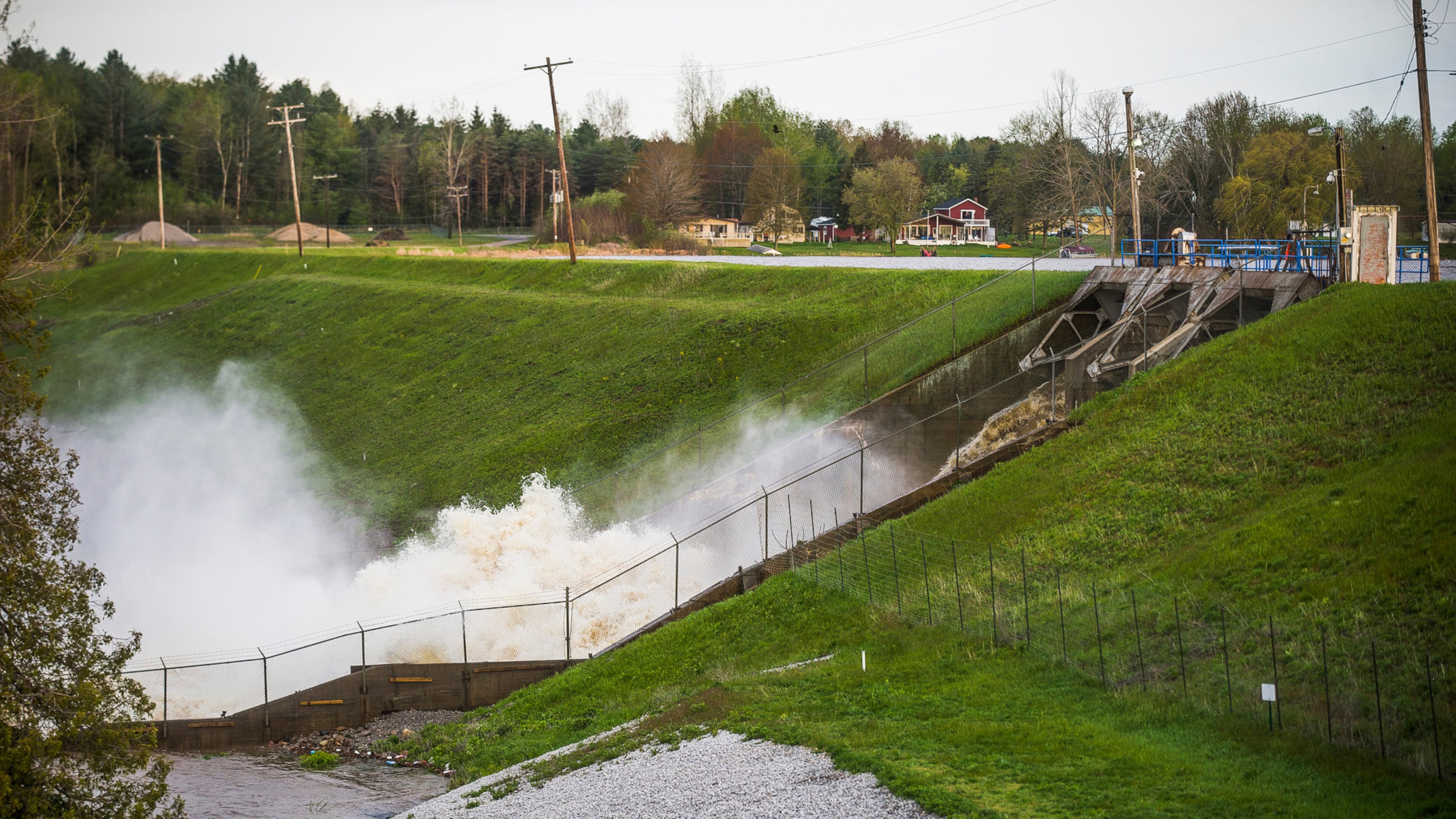 FILE - Water rushes through the Edenville Dam, May 19, 2020, in Edenville, Mich. (Katy Kildee/Midland Daily News via AP, File)