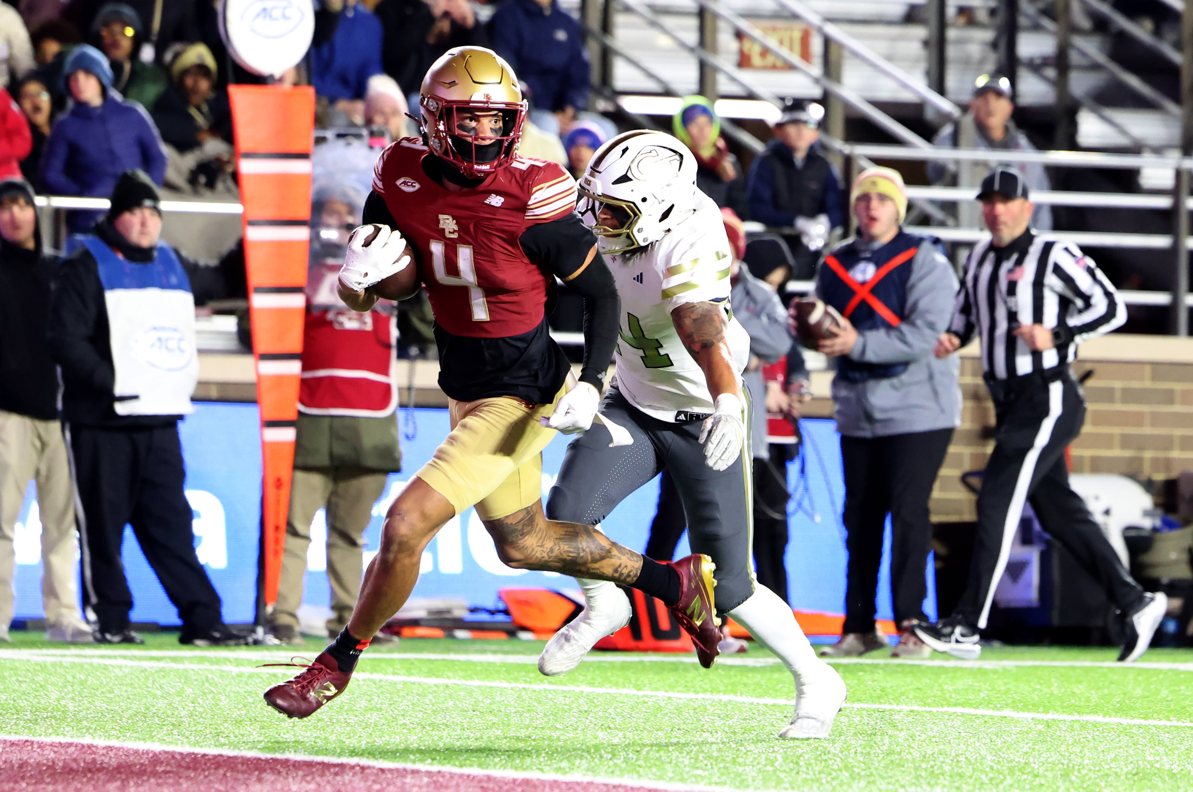 Boston College wide receiver Reed Harris, left, runs into the end zone for a touchdown as Georgia Tech linebacker Kyle Efford, right, pursues during the second half of an NCAA college football game Saturday, Nov. 15, 2025, in Boston. (AP Photo/Mark Stockwell)