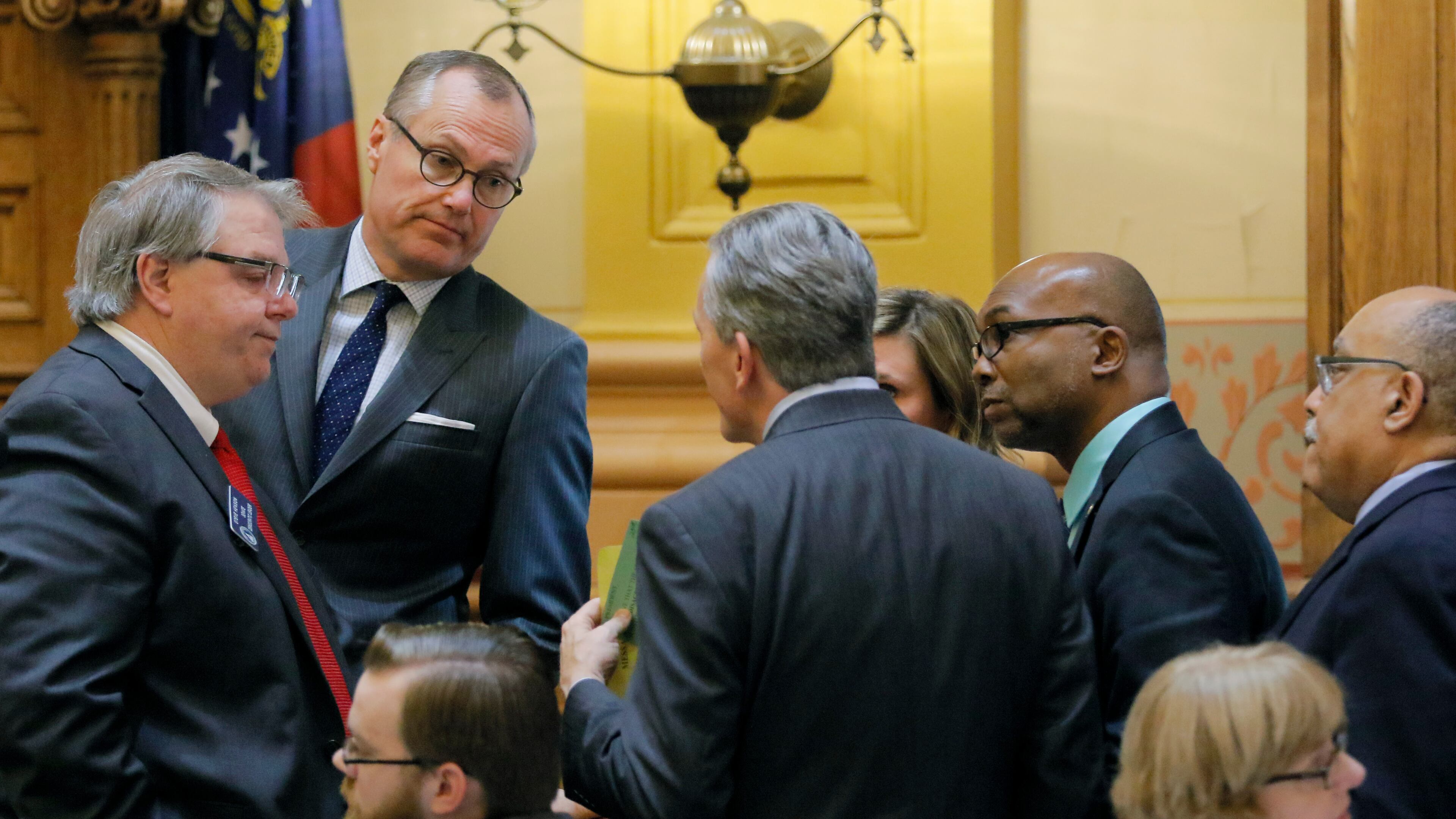 Mar. 30, 2017 - Atlanta - Senate members, including Senator Steve Henson (from left), D-Stone Mountain, Lt. Gov. Casey Cagle, Senator Jesse Stone, R-Waynesboro, Senator Elena Parent, D-Atlanta, Senator Harold V. Jones II, D-Augusta, and Senator Vincent Fort, D-Atlanta huddle on the 40th and final legislative day of the 2017 General Assembly. BOB ANDRES /BANDRES@AJC.COM