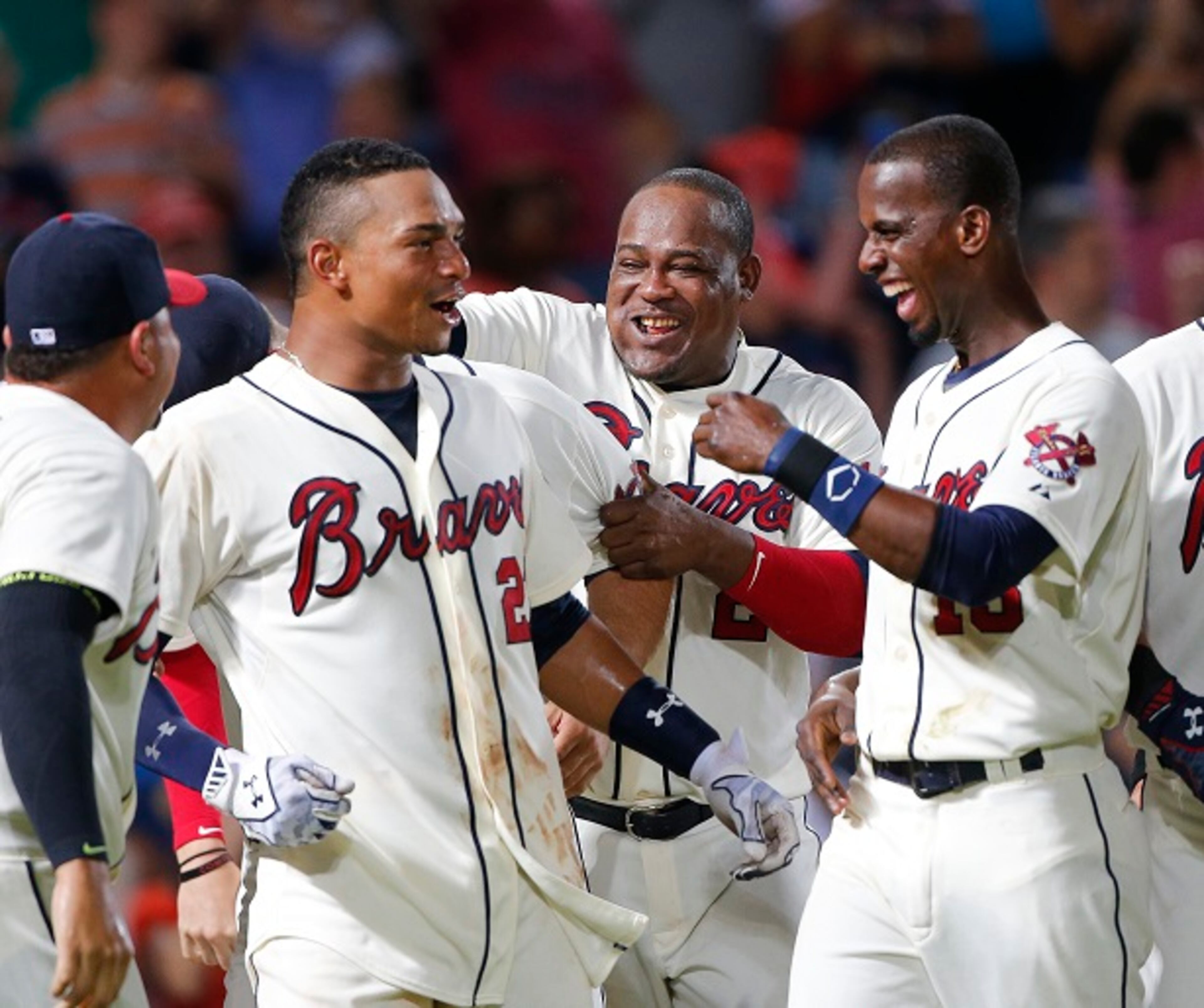Atlanta Braves catcher Christian Bethancourt, left, celebrates with Juan Uribe, and Pedro Ciriaco, right, after hitting a game-winning home run in the bottom of the 9th inning to defeat Pittsburgh Pirates 5-4 in baseball game Saturday, June 6, 2015, in Atlanta. (AP Photo/John Bazemore)