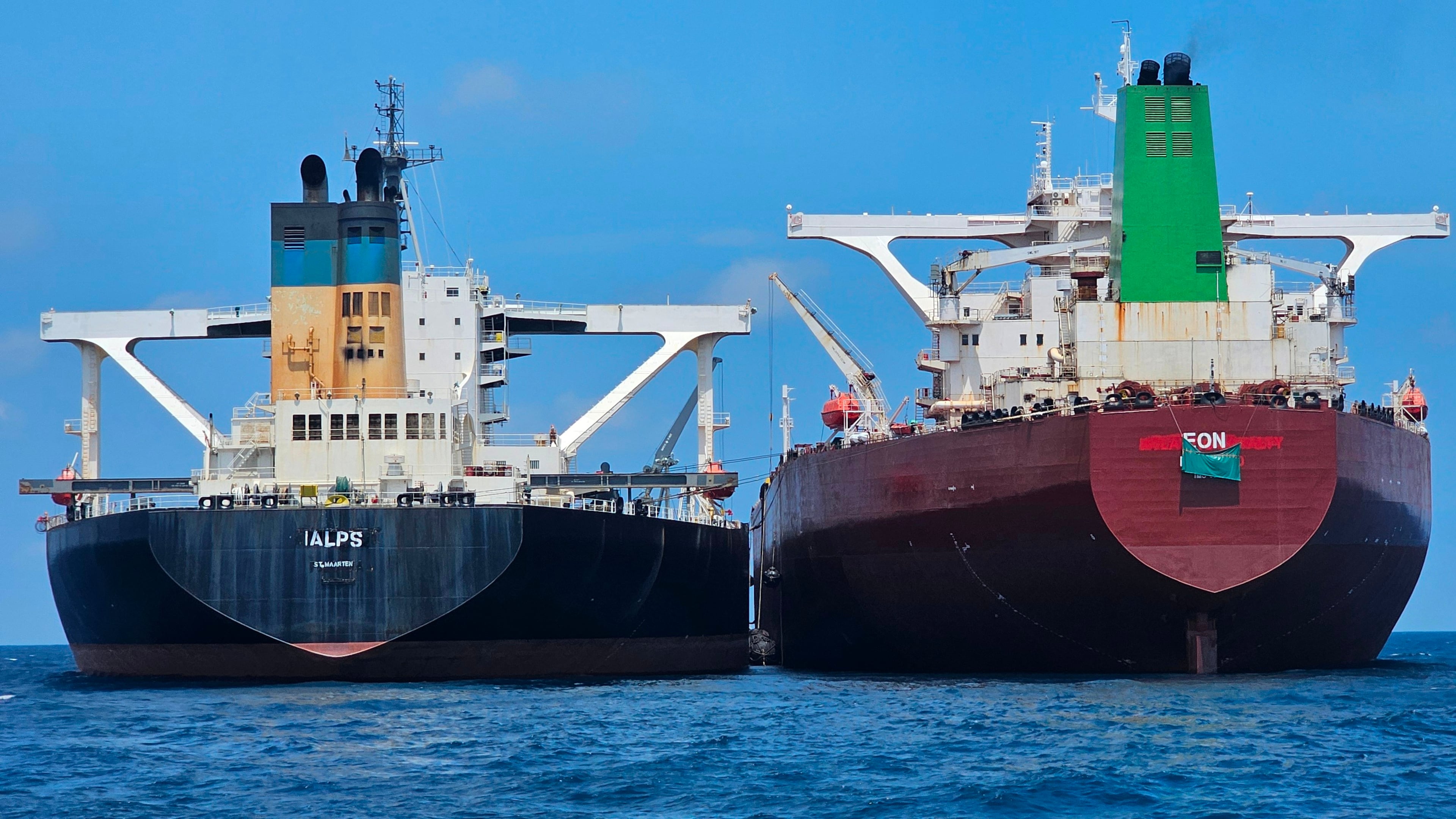 This handout photo from United Against Nuclear Iran shows two oil tankers making a ship-to-ship transfer of Iranian oil in the Eastern Outer Port Limits (EOPL), 70 kilometers off Malaysia's coast in international waters on 28 July 2025. (Charlie Brown/United Against Nuclear Iran via AP)
