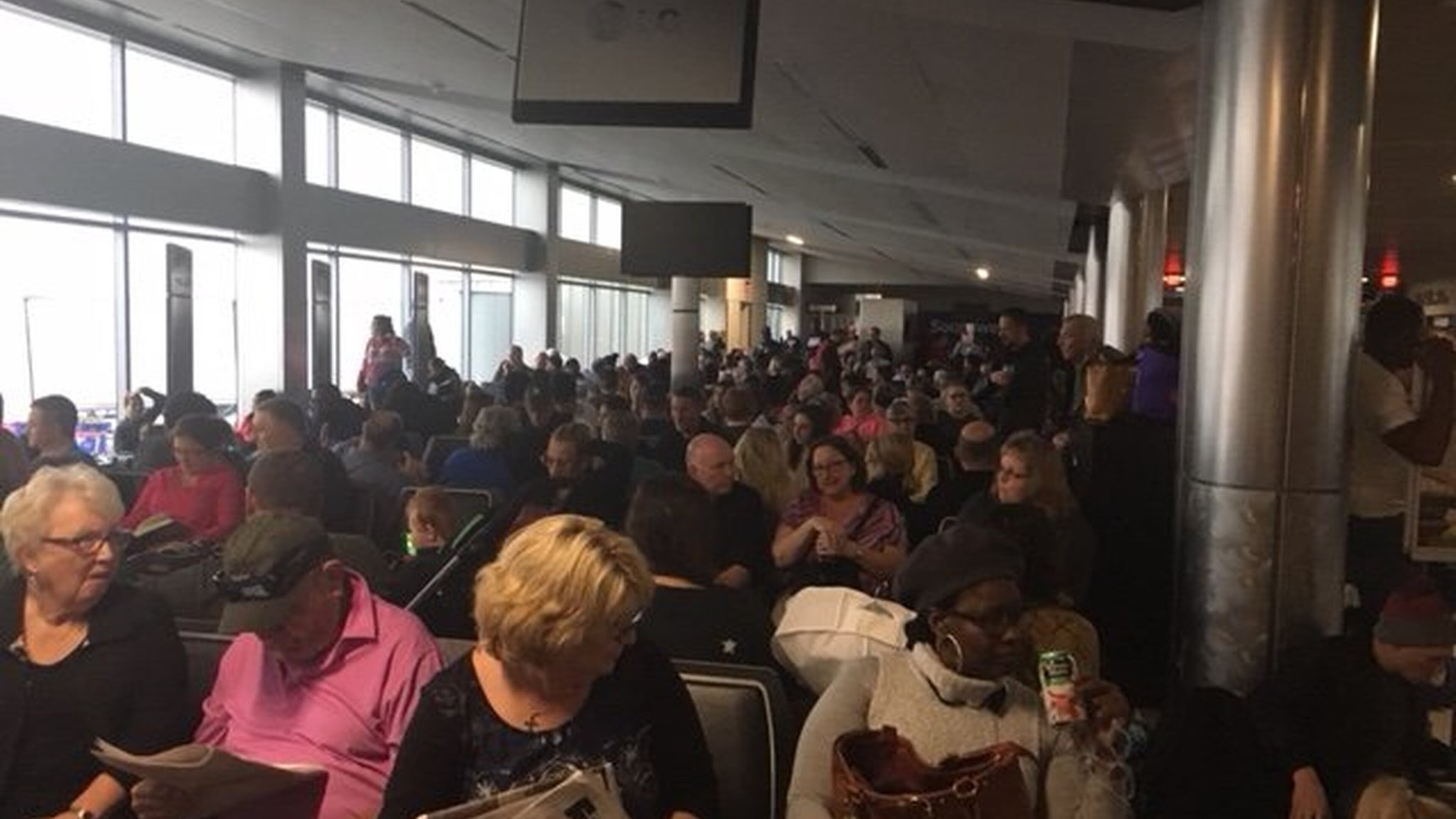 Passengers wait to exit Concourse C on Dec. 17, 2017, after power at Hartsfield-Jackson International Airport had been out for about three hours. (Photo by Rick Crotts / AJC)