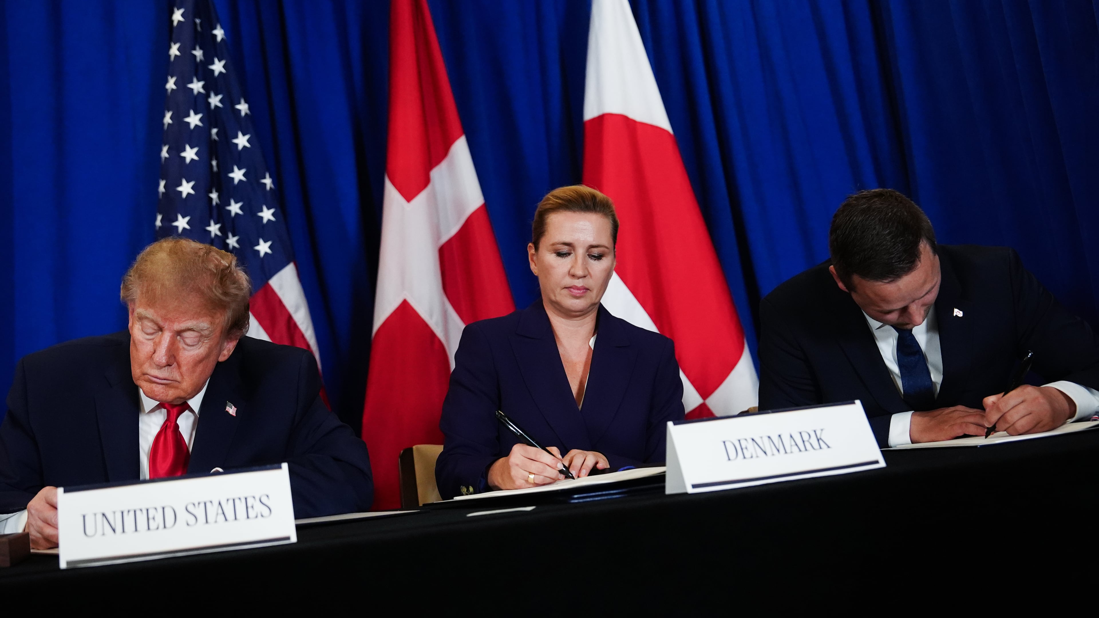 President Donald Trump signs a security agreement with Denmark's Prime Minister Mette Frederiksen and Greenland's Prime Minister Jens-Frederik Nielsen during the United Nations General Assembly, Tuesday, Sept. 22, 2026, at the UN headquarters. (AP Photo/Julia Demaree Nikhinson)