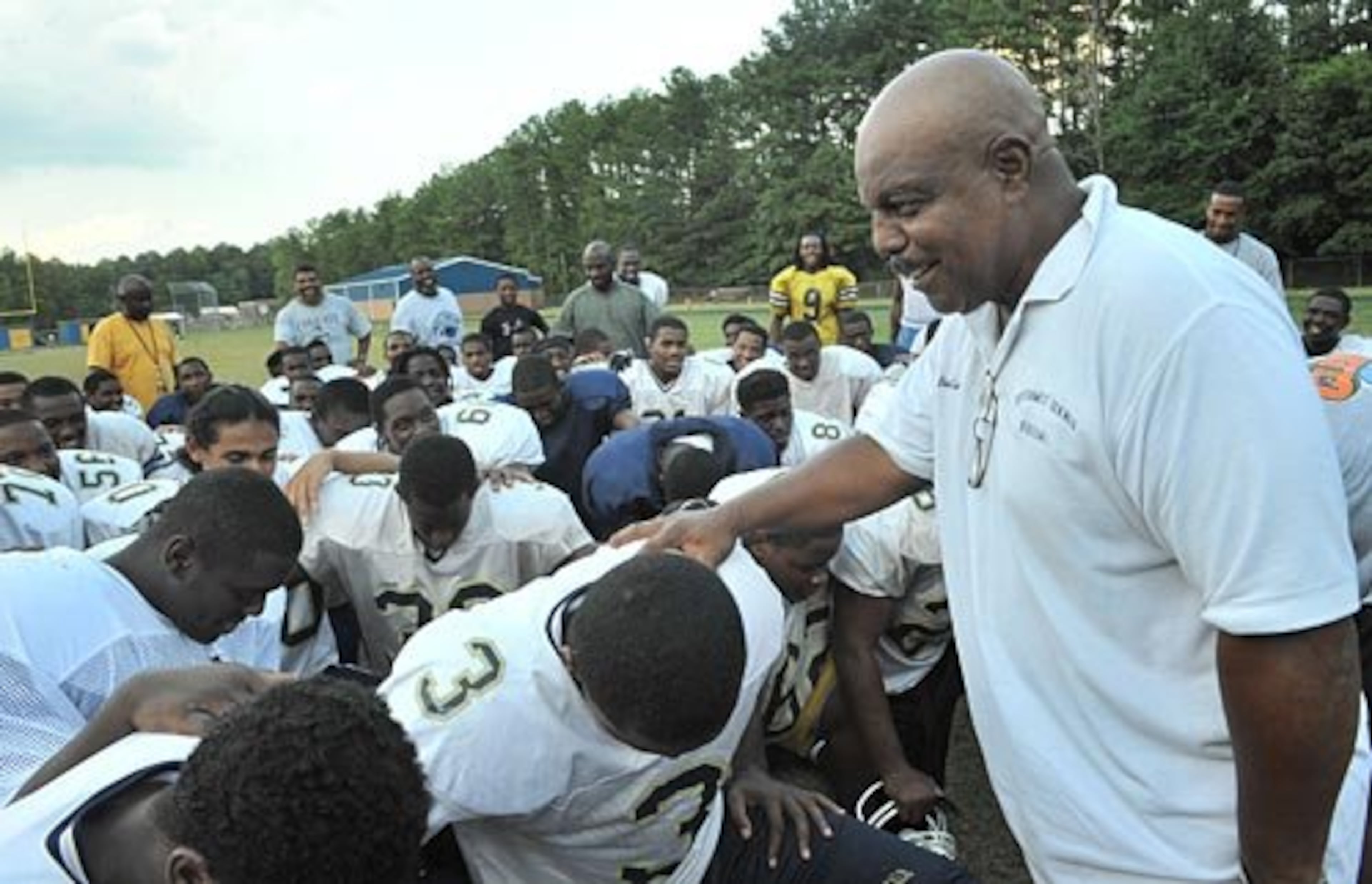 Southwest DeKalb football coach Buck Godfrey (right) speaks as the team was dismissed after practice in 2008. (Hyosub Shin/AJC)