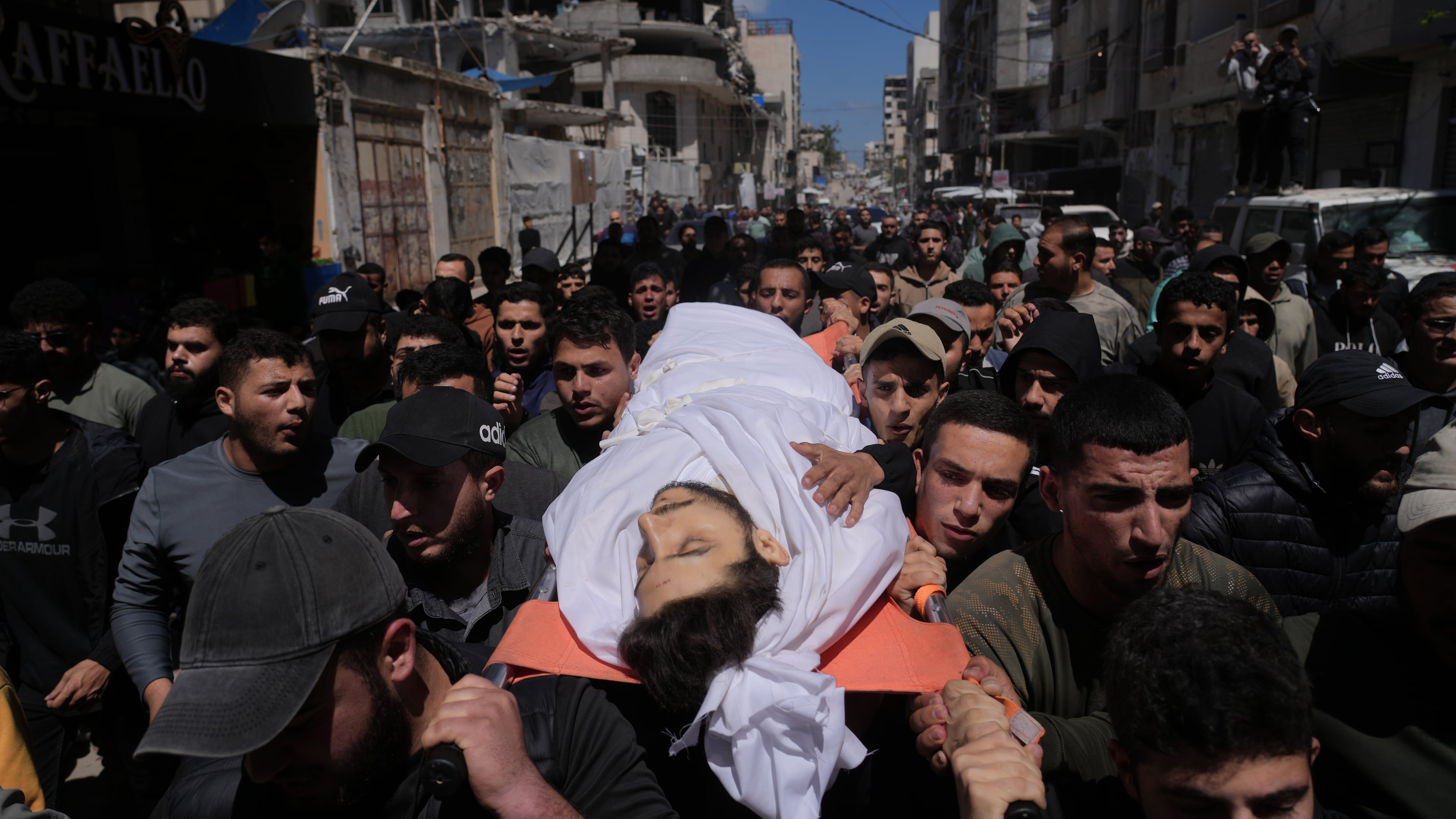 Mourners carry the body of Azzam al-Hayya, son of Hamas leader Khalil al-Hayya, mourn over his body after he was killed in an Israeli airstrike, at Shifa Hospital in Gaza City Thursday, May 7, 2026. (AP Photo/Jehad Alshrafi)
