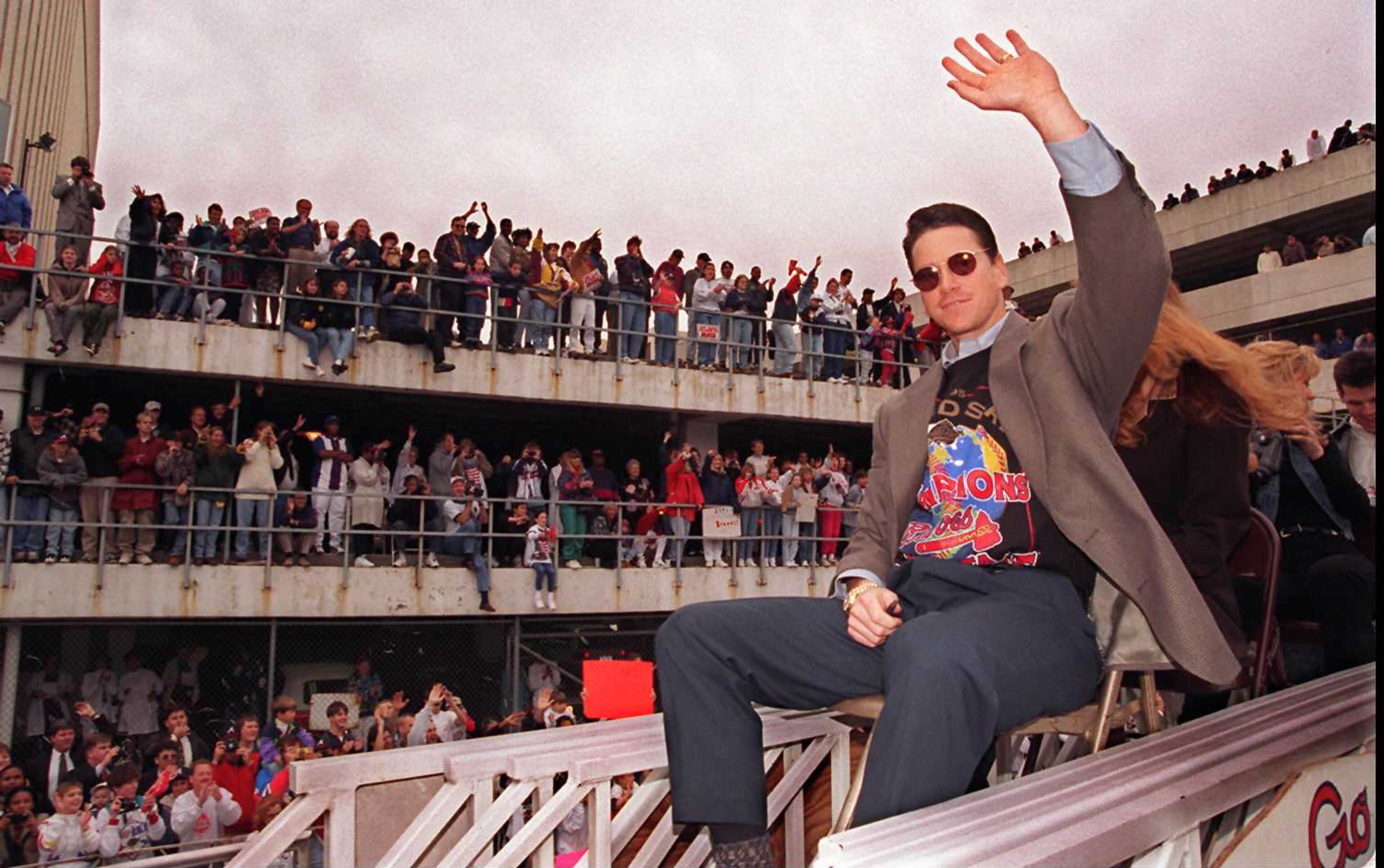 Tom Glavine, the World Series' Most Valuable Player, waves to fans during a parade in Atlanta after the Braves won the World Series.