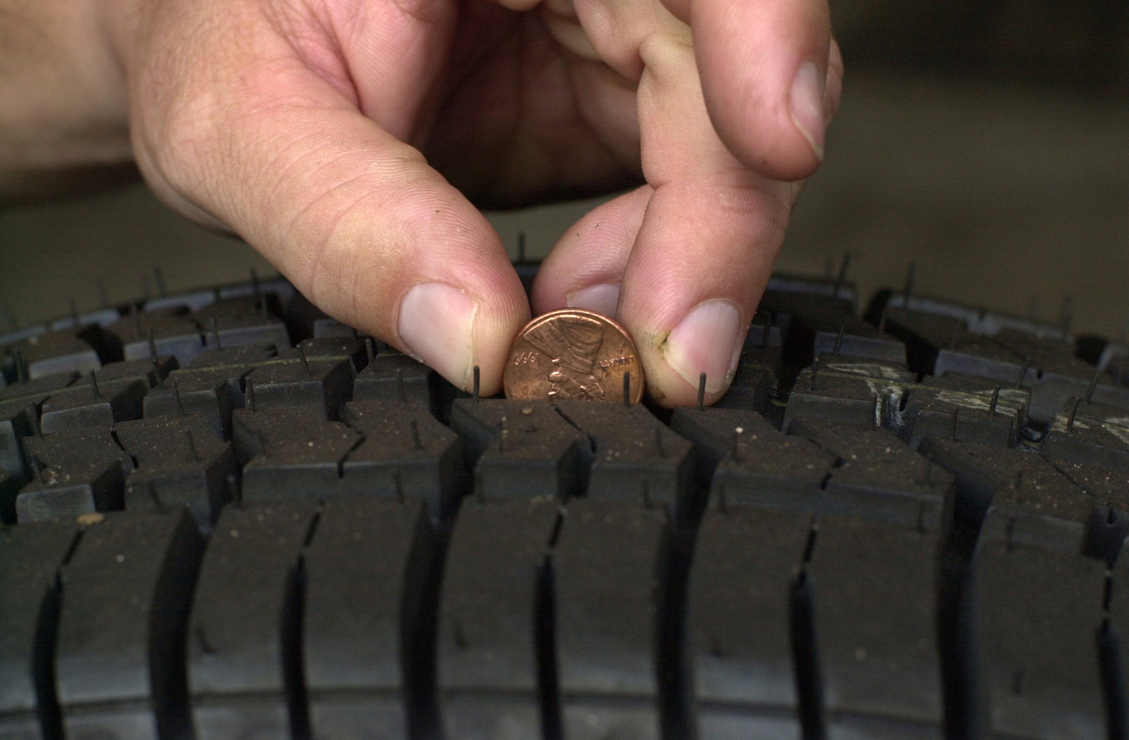 The time-tested "penny" method for checking the tread on a tire. Since the U.S. mint phasing out the penny, Road Ready now recommends the “quarter test." (AJC FILE)