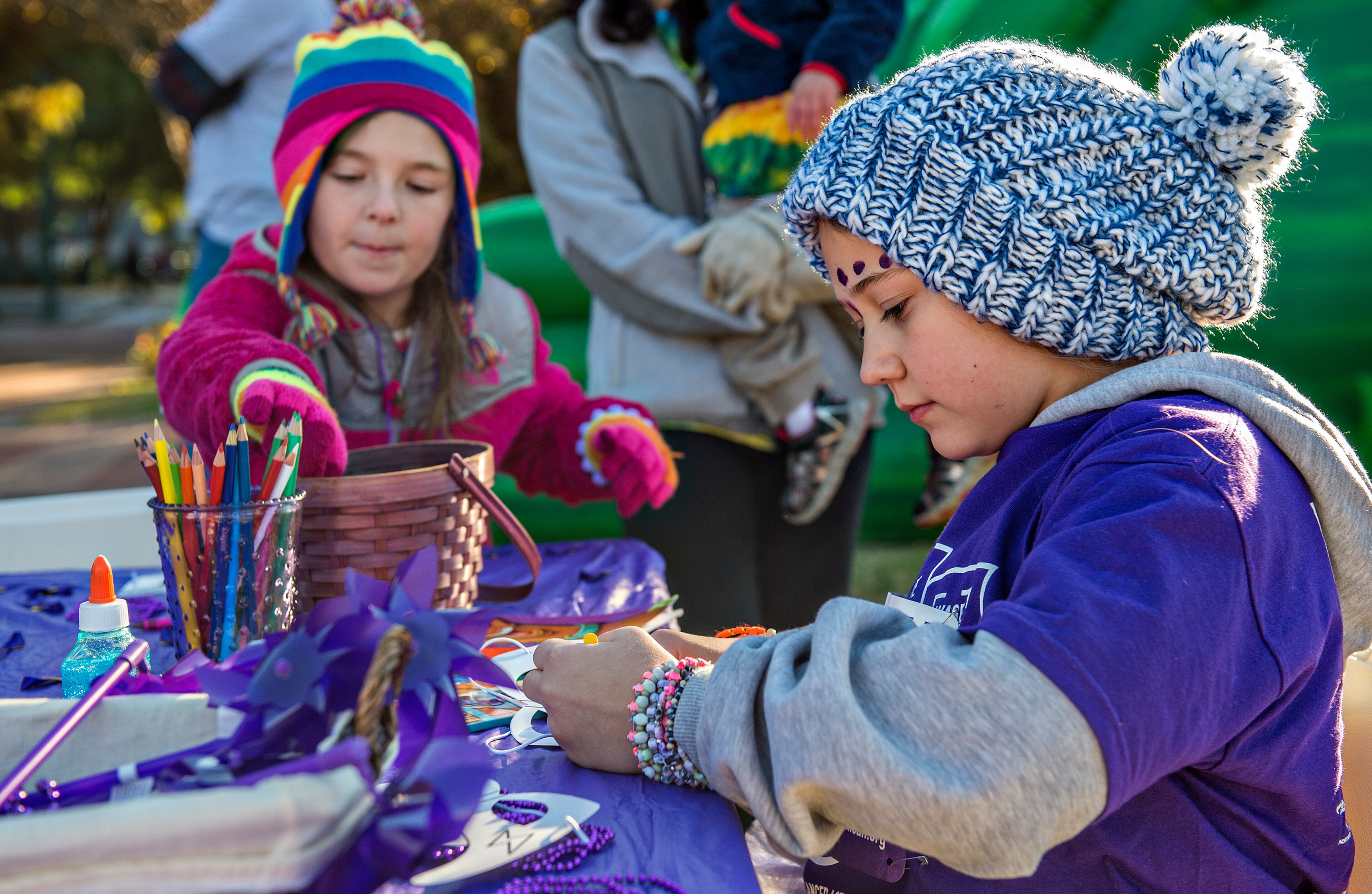 November 14, 2015 Atlanta - Kaycie Smith (right) and Allie Rainbow decorate masks before the start of the PurpleStride Atlanta 5k at Centennial Olympic Park in Atlanta on Saturday, November 14, 2015. Participants raised over $265,000 for the Pancreatic Cancer Action Network. JONATHAN PHILLIPS / SPECIAL