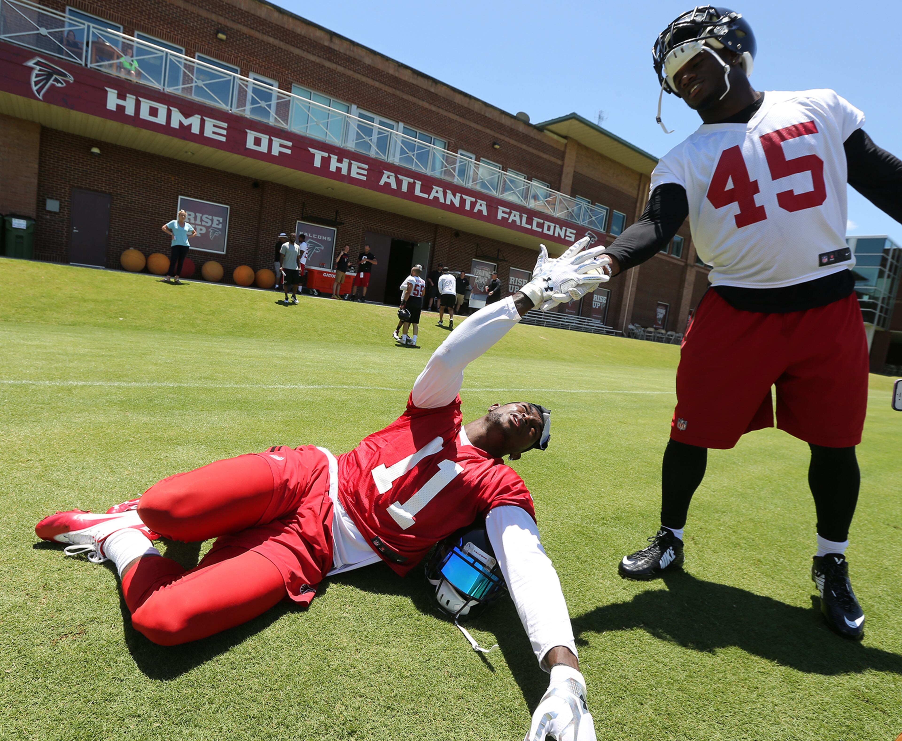 Falcons wide receiver Julio Jones gets five from linebacker Deion Jones during an OTA day on Tuesday, June 7, 2016, in Flowery Branch. Curtis Compton / ccompton@ajc.com