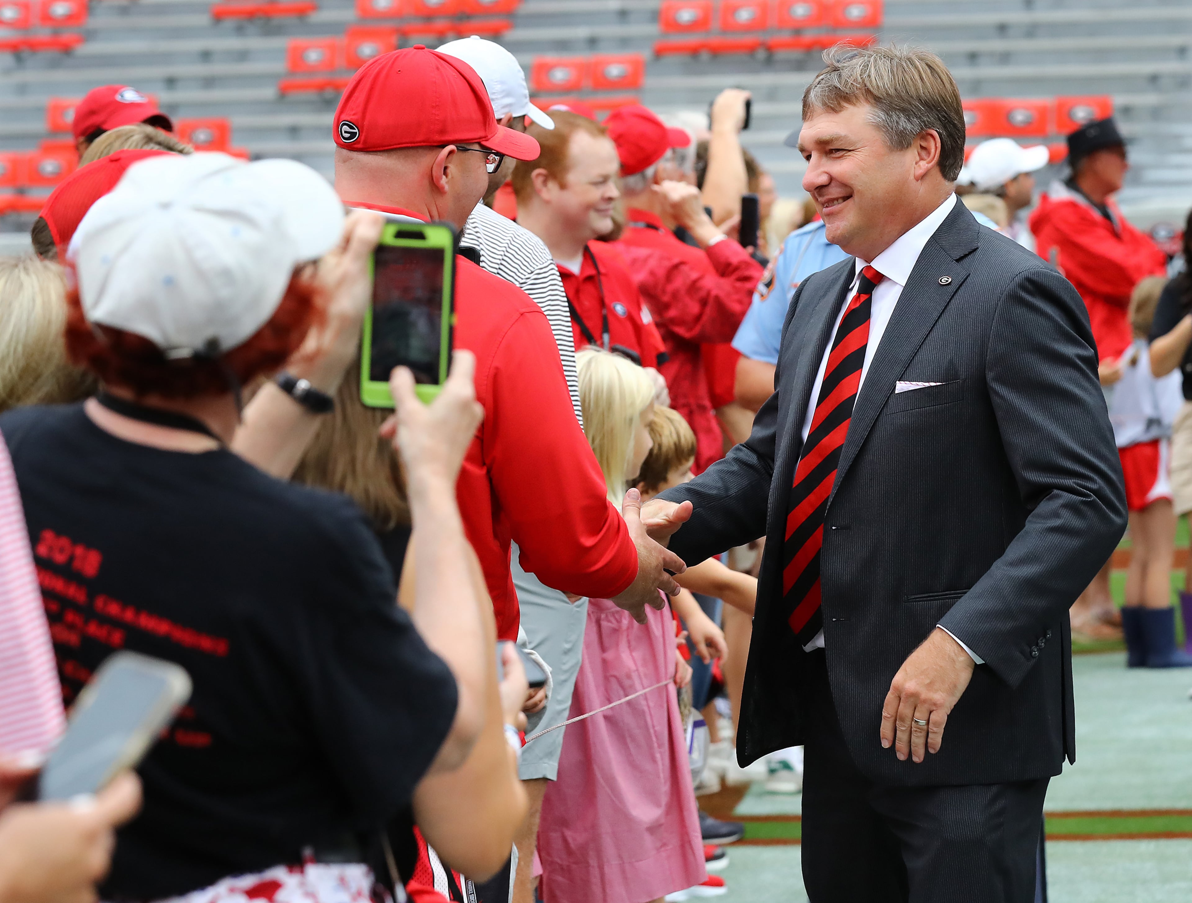 Georgia head coach Kirby Smart greets a fan during the Dawg Walk while the team arrives to play Samford in a NCAA college football game on Saturday, Sept. 10, 2022, in Athens. “Curtis Compton / Curtis Compton@ajc.com