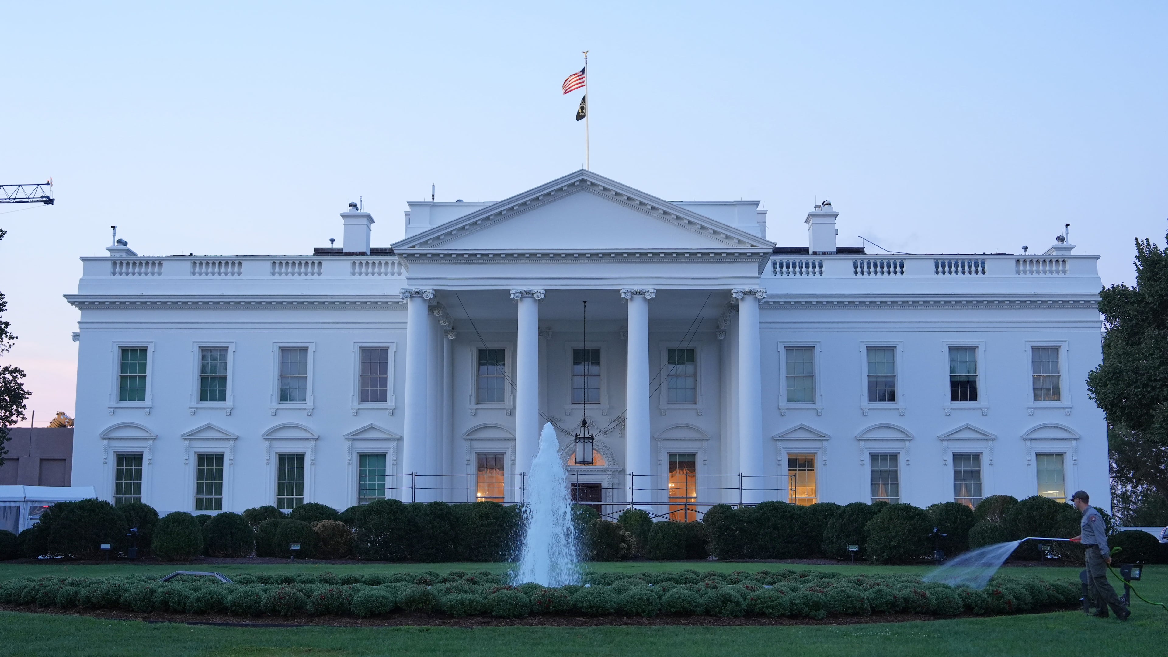 A worker waters plants on the North Lawn of the White House Monday, Sept. 21, 2026, in Washington. (AP Photo/Mark Schiefelbein)