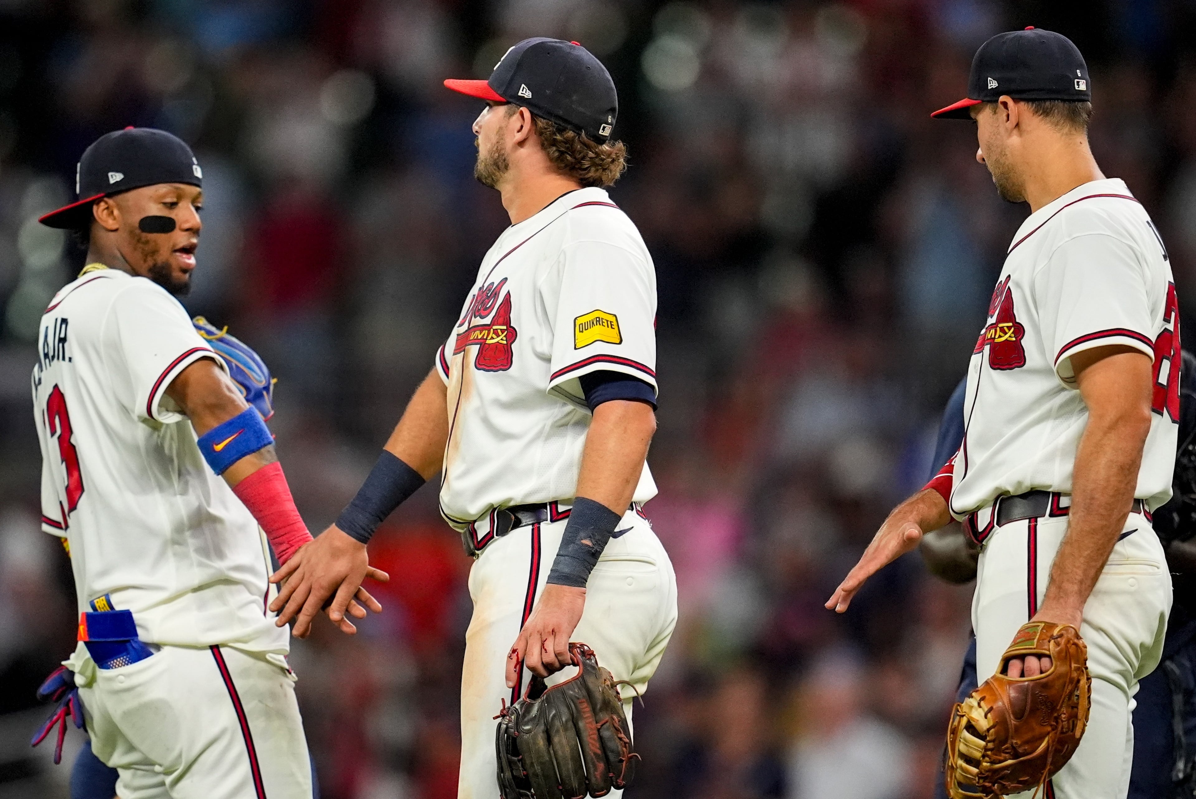 The Braves’ Ronald Acuña Jr. (from left), Austin Riley and Matt Olson celebrate Tuesday’s win over the Marlins. (Mike Stewart/AP)