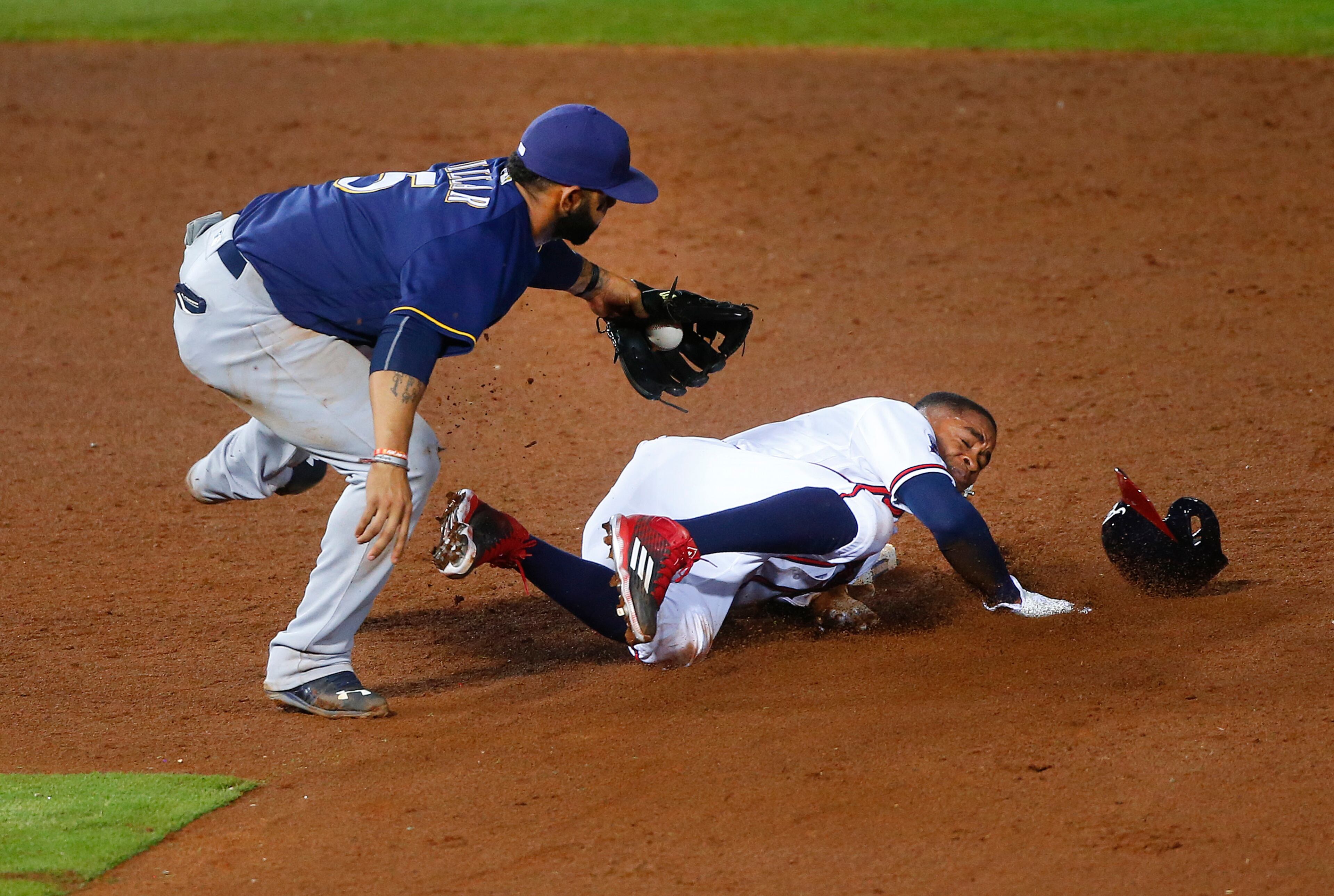 Atlanta Braves' Mallex Smith is tagged out by Milwaukee Brewers shortstop Jonathan Villar (5) as he tried to steal second base during the sixth inning of a baseball game Wednesday, May 25, 2016, in Atlanta. (AP Photo/John Bazemore)