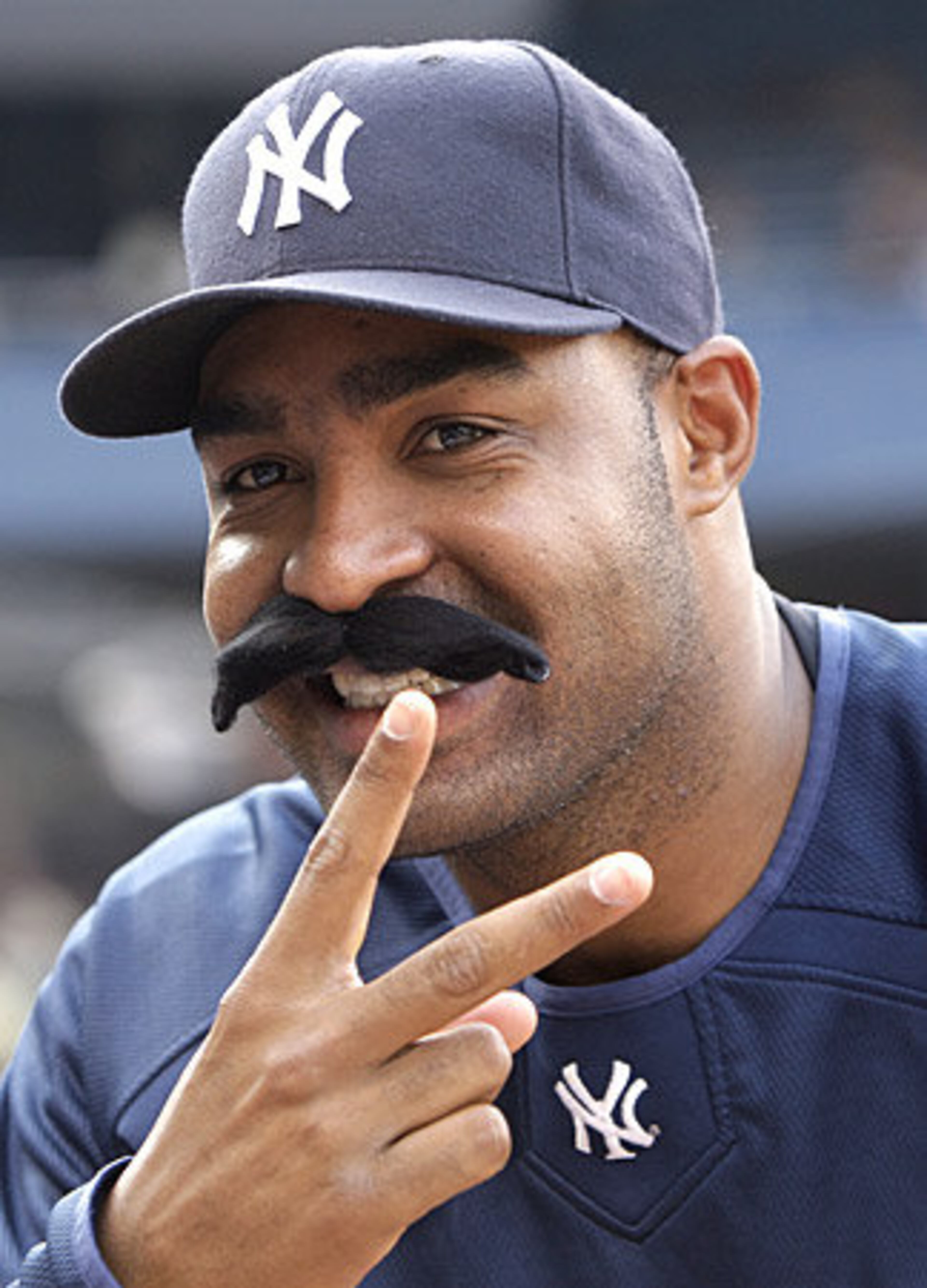 On a much less serious note, Yankees pitcher Jose Veras tries on a Giambi-esque 'stache for size. Literally. The team handed out fake mustaches to fans as a way to spur 2008 All-Star voting for Giambi.