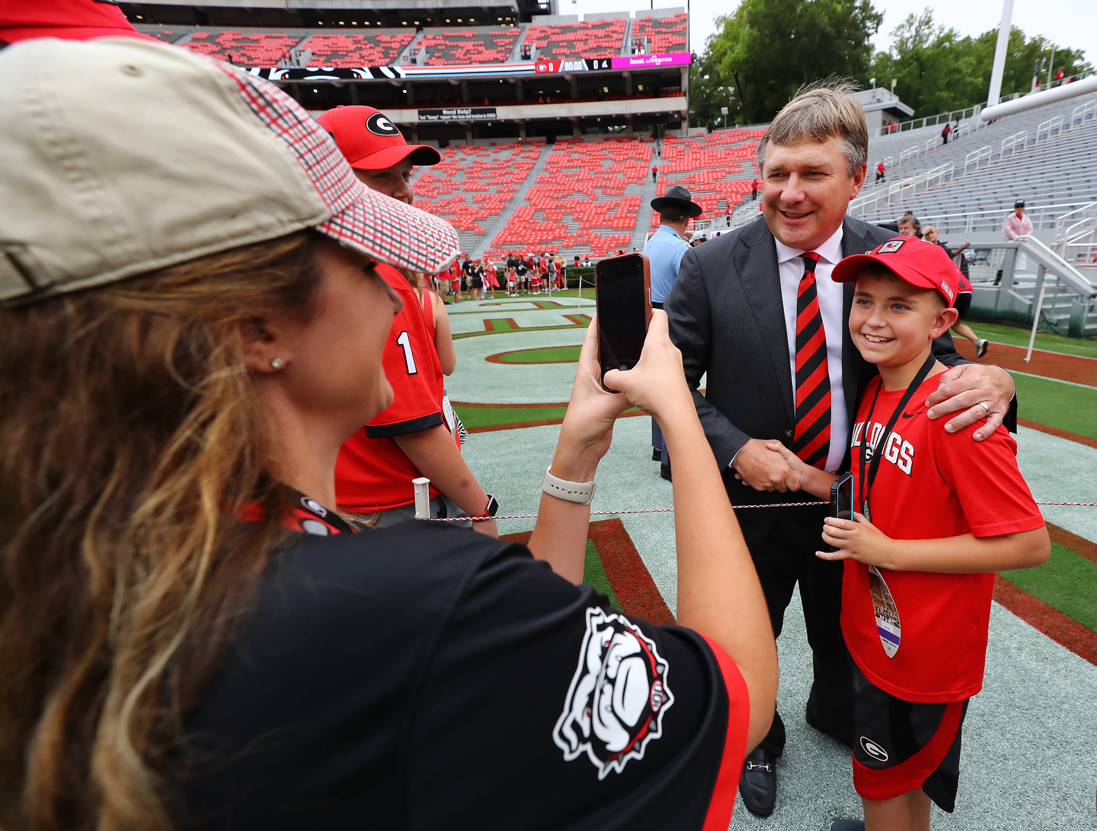 Georgia head coach Kirby Smart pauses for a photo with his namesake Kirby Spain, Flowery Branch, while greeting Georgia fans during the Dawg Walk while the team arrives to play Samford in a NCAA college football game on Saturday, Sept. 10, 2022, in Athens. “Curtis Compton / Curtis Compton@ajc.com