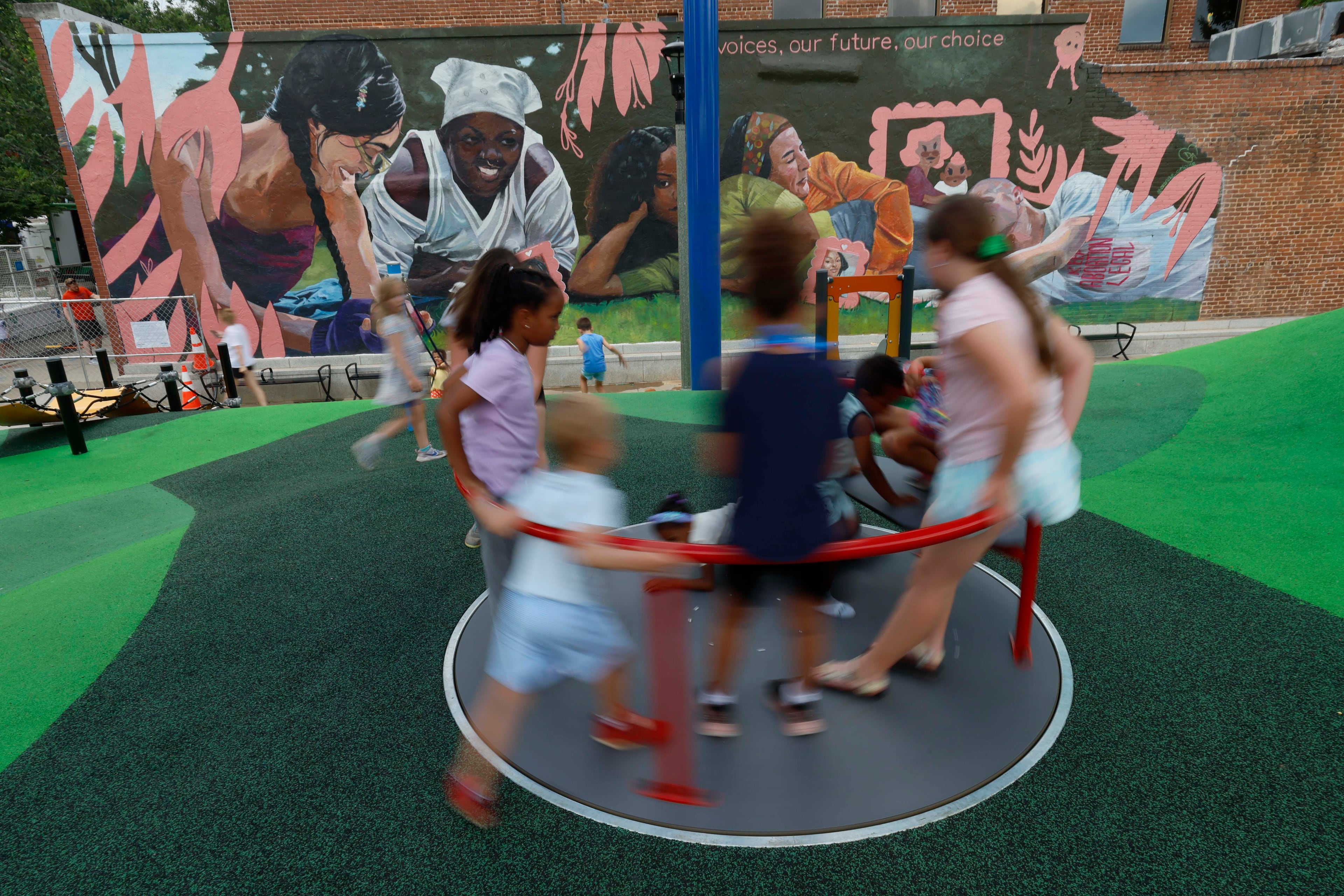 Children play on the new playground in Decatur Square during Decatur WatchFest ’26 on Thursday, June 25, 2026. (Miguel Martinez/AJC)