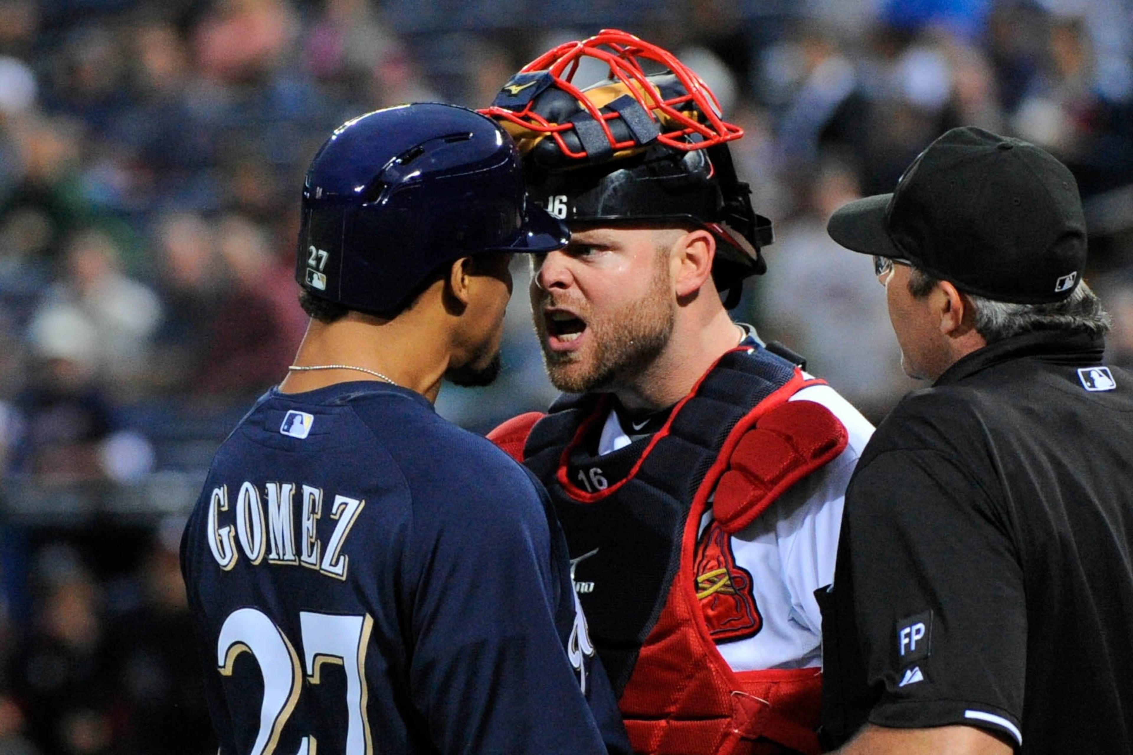 Sep 25, 2013; Atlanta, GA, USA; Milwaukee Brewers center fielder Carlos Gomez (27) reacts with Atlanta Braves catcher Brian McCann (16) after hitting a home run during the first inning at Turner Field. Dale Zanine-USA TODAY Sports