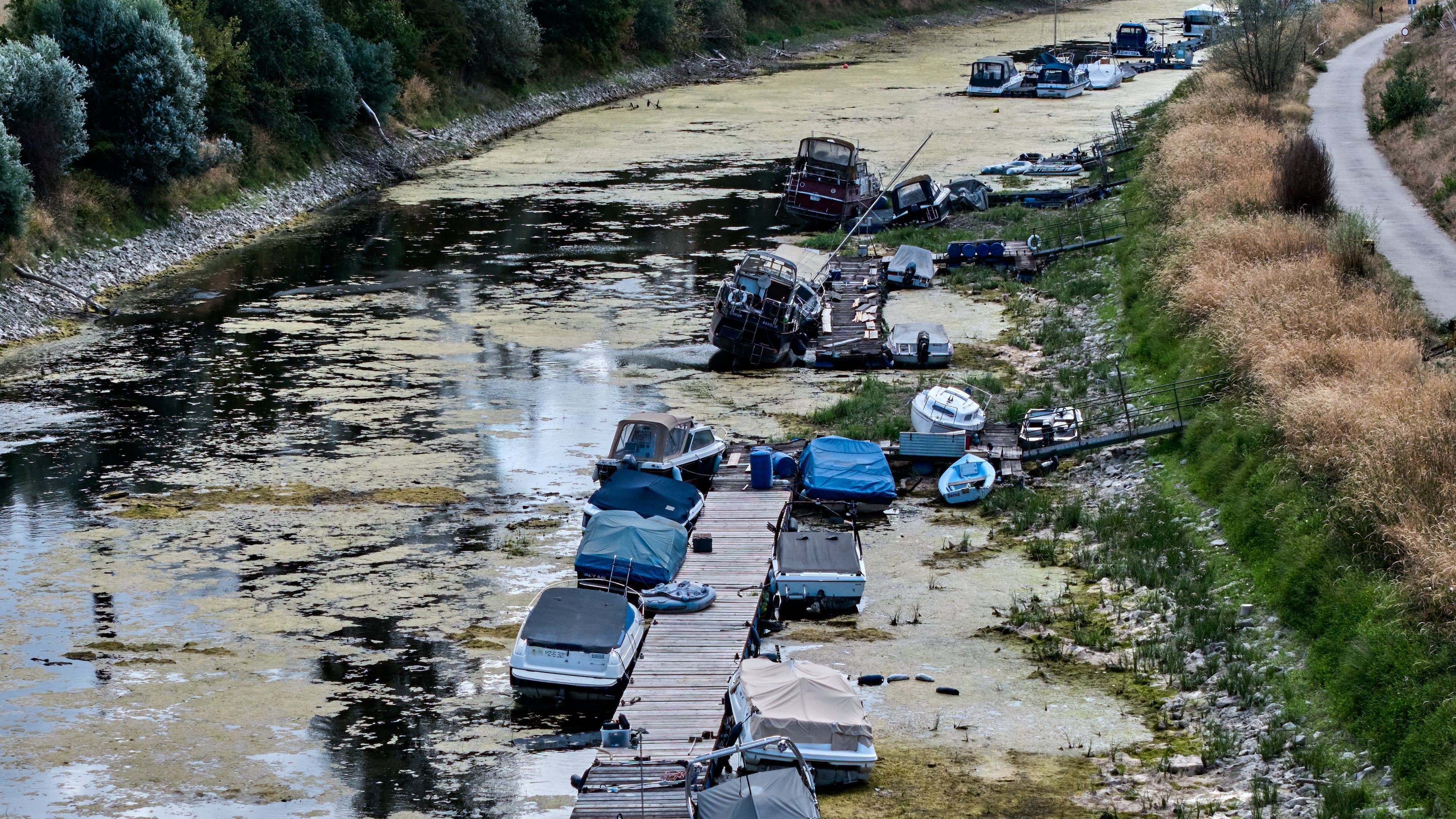 Boats are stranded in a side arm of the river Rhine that is running out of water in Mackenheim near Mainz, Germany Monday, Aug. 10, 2026. (AP Photo/Michael Probst)