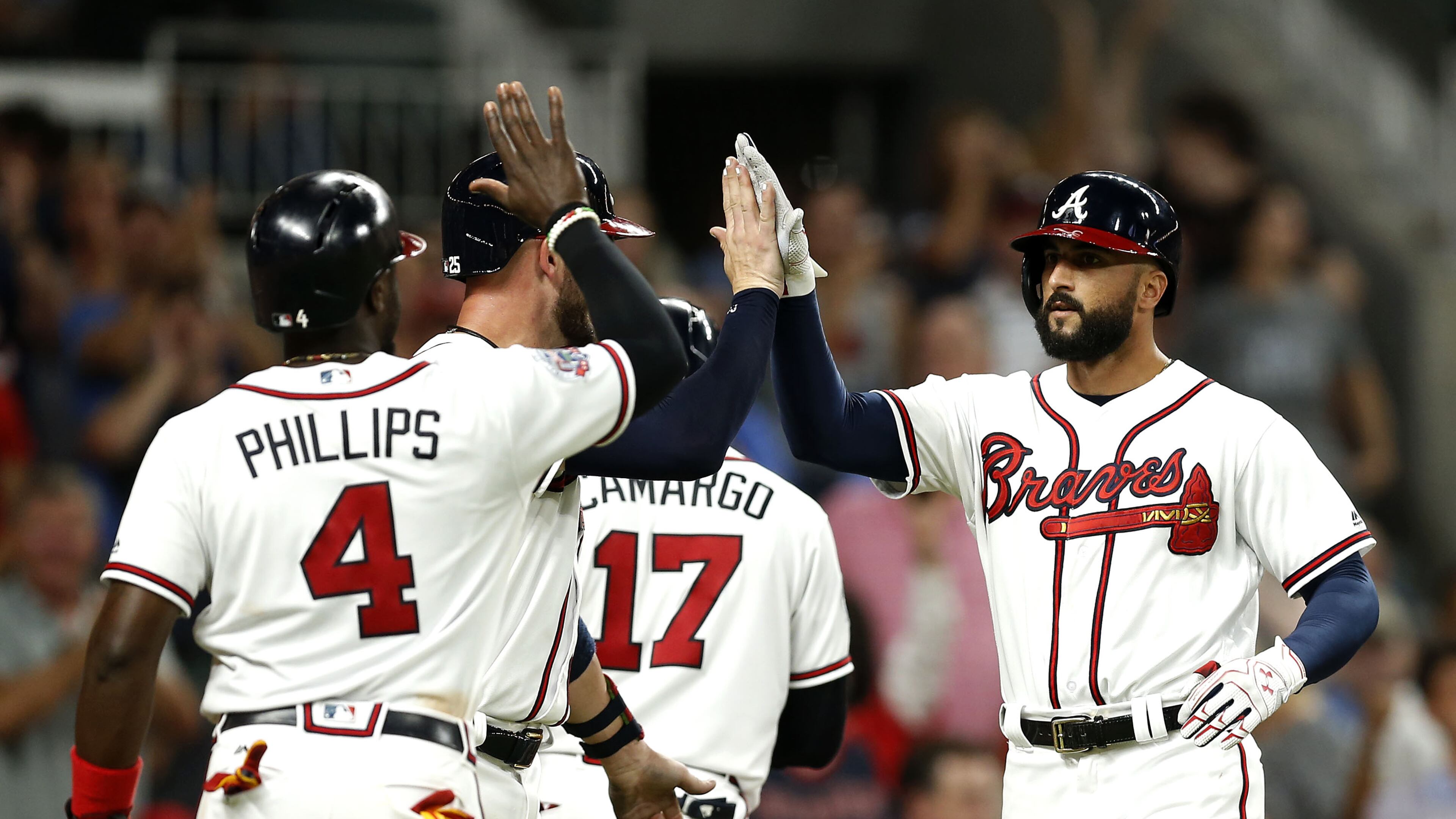 Right fielder Nick Markakis of the Atlanta Braves (right) is congratulated by teammates after hitting a 3-run home run in the sixth inning during the game against the Miami Marlins at SunTrust Park on August 4, 2017 in Atlanta, Georgia. (Photo by Mike Zarrilli/Getty Images)