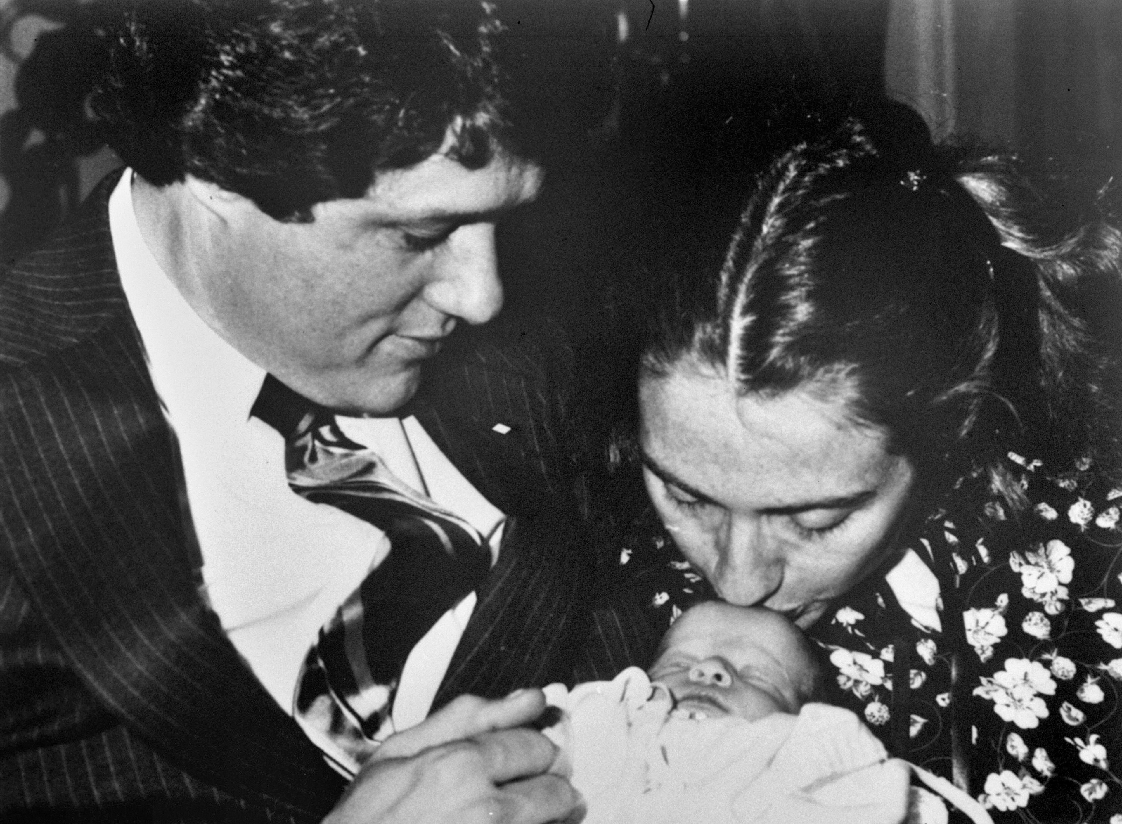 In this March 5, 1980 file photo, Arkansas Gov. Bill Clinton and his wife, Hillary Rodham, 33, hold their week-old baby daughter, Chelsea in Little Rock, Ark. (AP Photo/Donald R. Broyles)