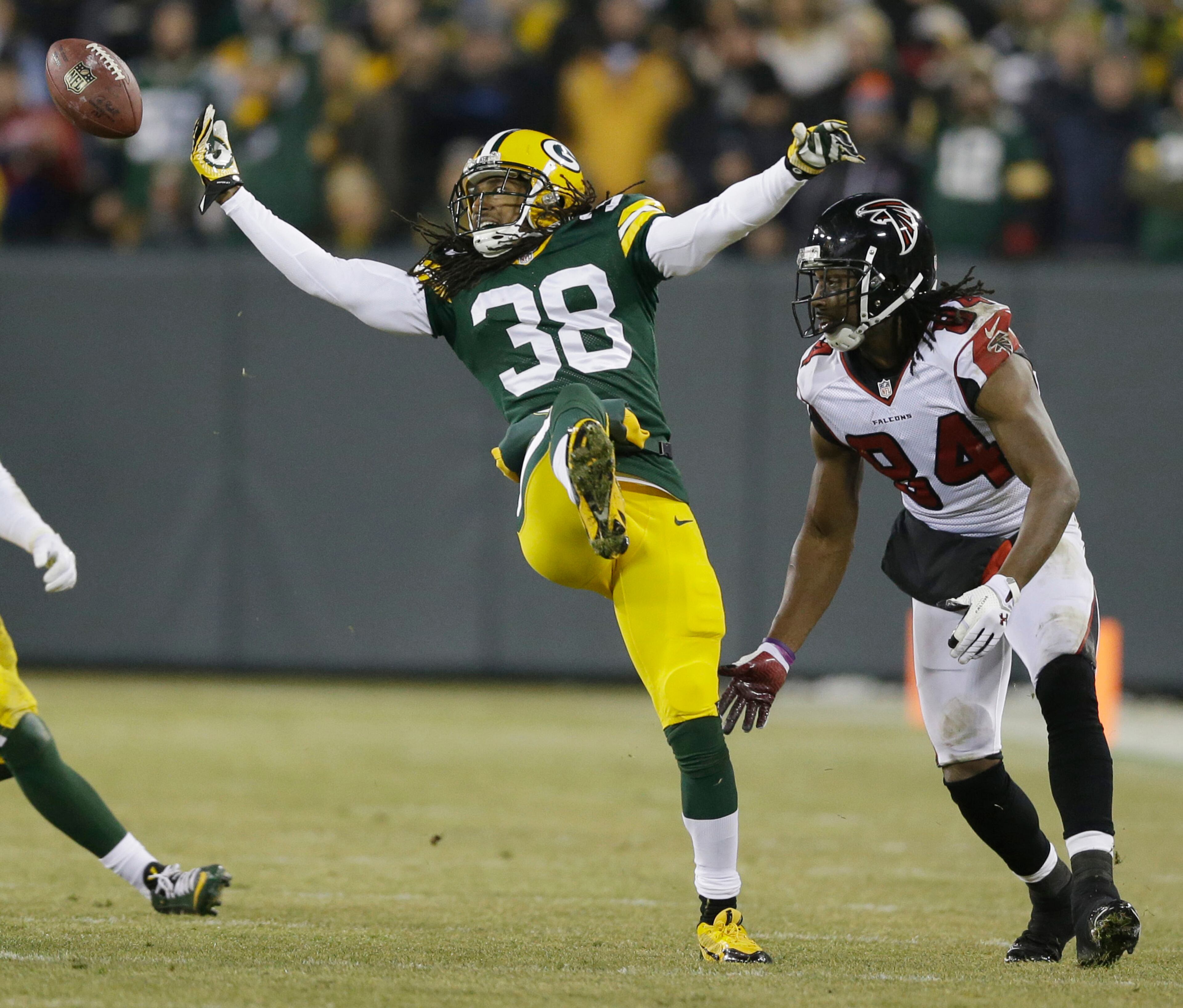 Green Bay Packers' Tramon Williams breaks up a pass intended for Atlanta Falcons' Roddy White during the first half Monday, Dec. 8, 2014, in Green Bay, Wis. The Falcons scored 24 points in a row to lead the Falcons 31-7 at halftime.