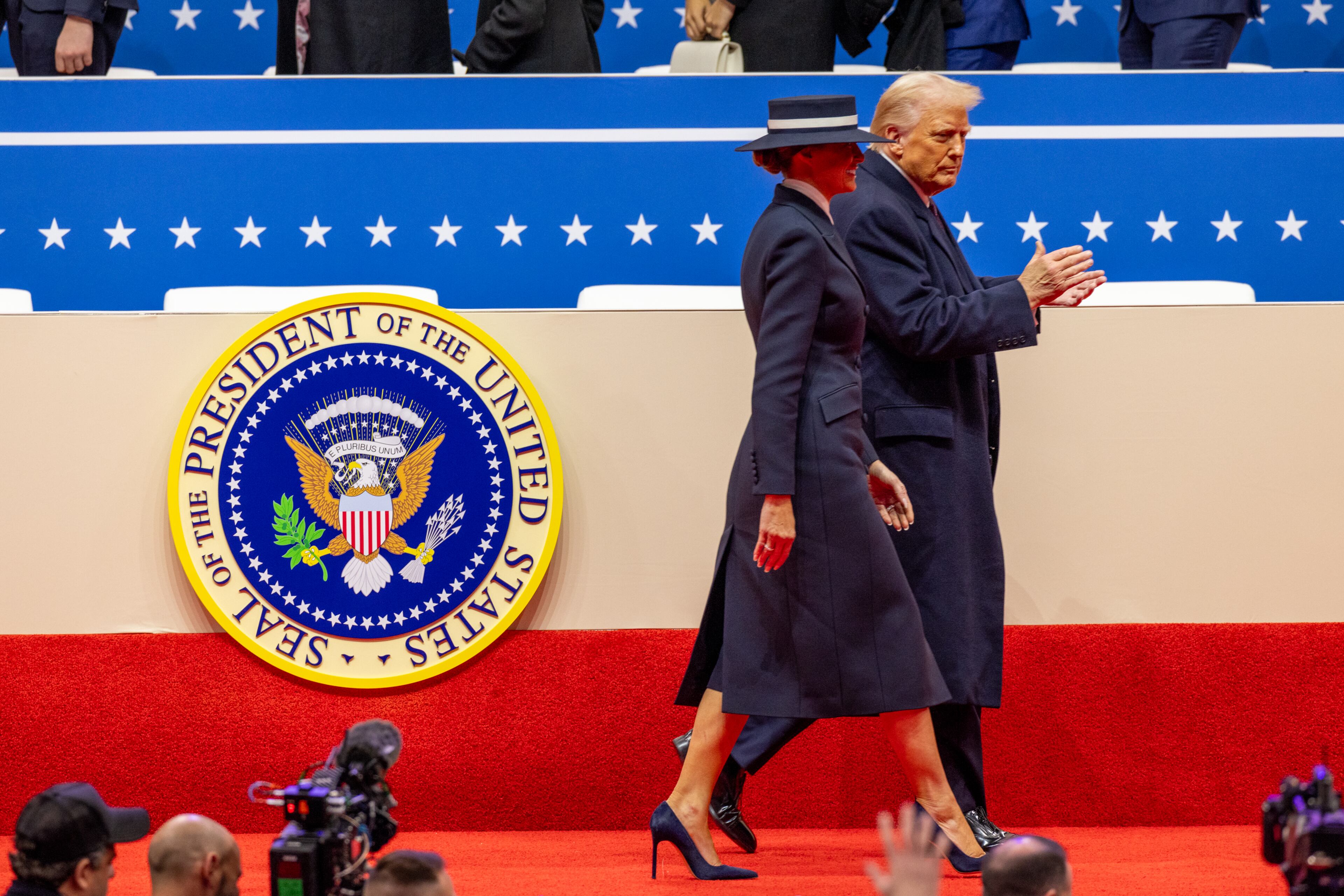 President Donald Trump and his wife Melanie walk off stage after the inaugural parade at Capital One Arena in Washington, D.C. on Monday, January 20, 2025. (Arvin Temkar / AJC)