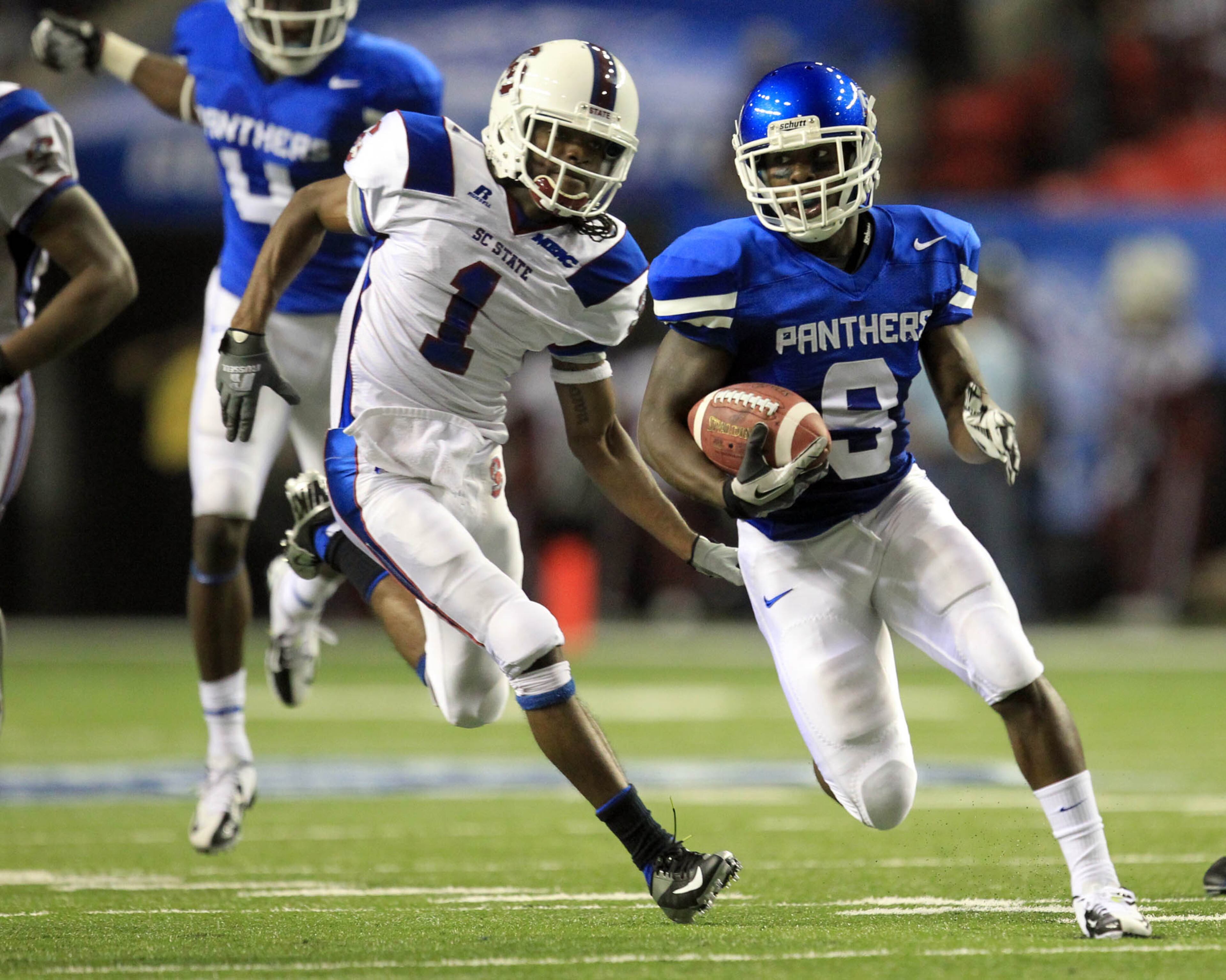 August 30, 2012 - Atlanta, Ga: Georgia State University corner back Brent McClendon (9) returns an interception ahead of South Carolina State wide receiver Lennel Elmore (1) in the first half of their game in the Georgia Dome Thursday night in Atlanta, Ga., August 30, 2012. JASON GETZ / JGETZ@AJC.COM