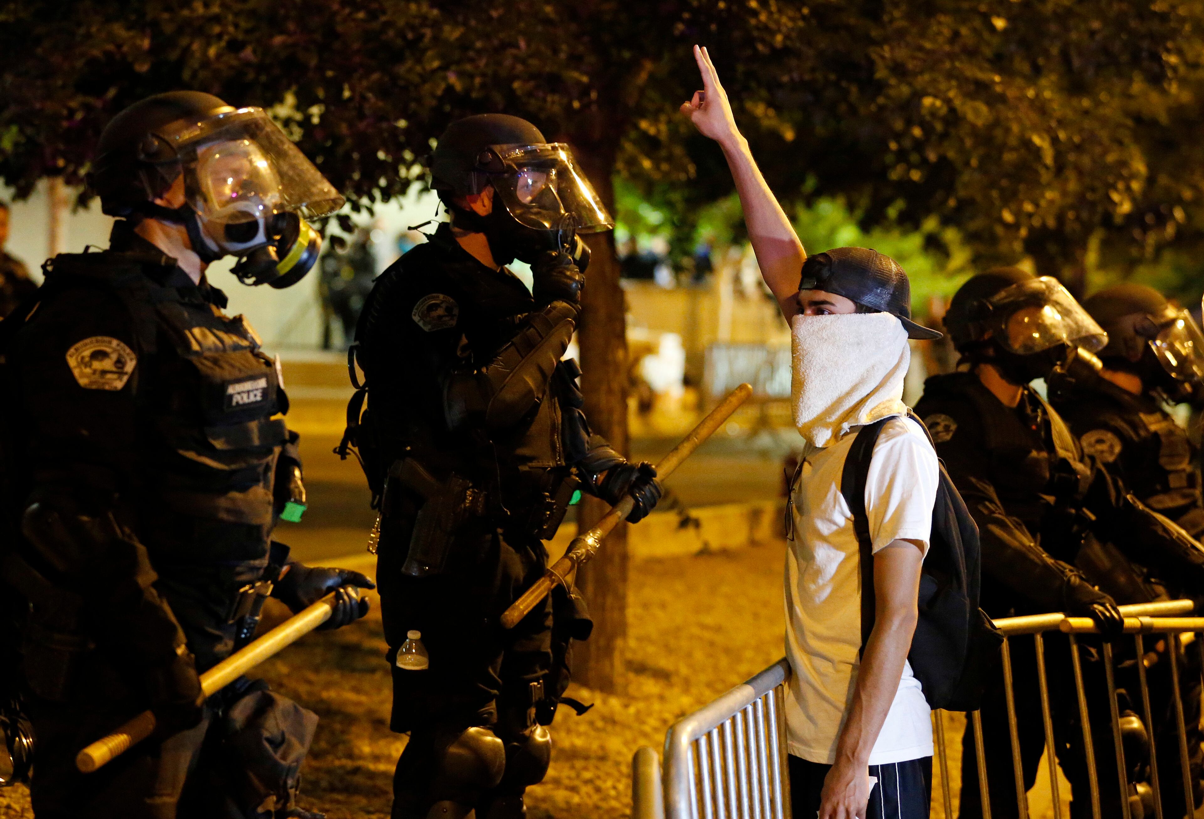 Riot police block off the Albuquerque Convention Center to anti-Trump protests following a rally and speech by Republican presidential candidate Donald Trump at the convention center where the event was held, in Albuquerque, N.M., Tuesday, May 24, 2016. (AP Photo/Brennan Linsley)