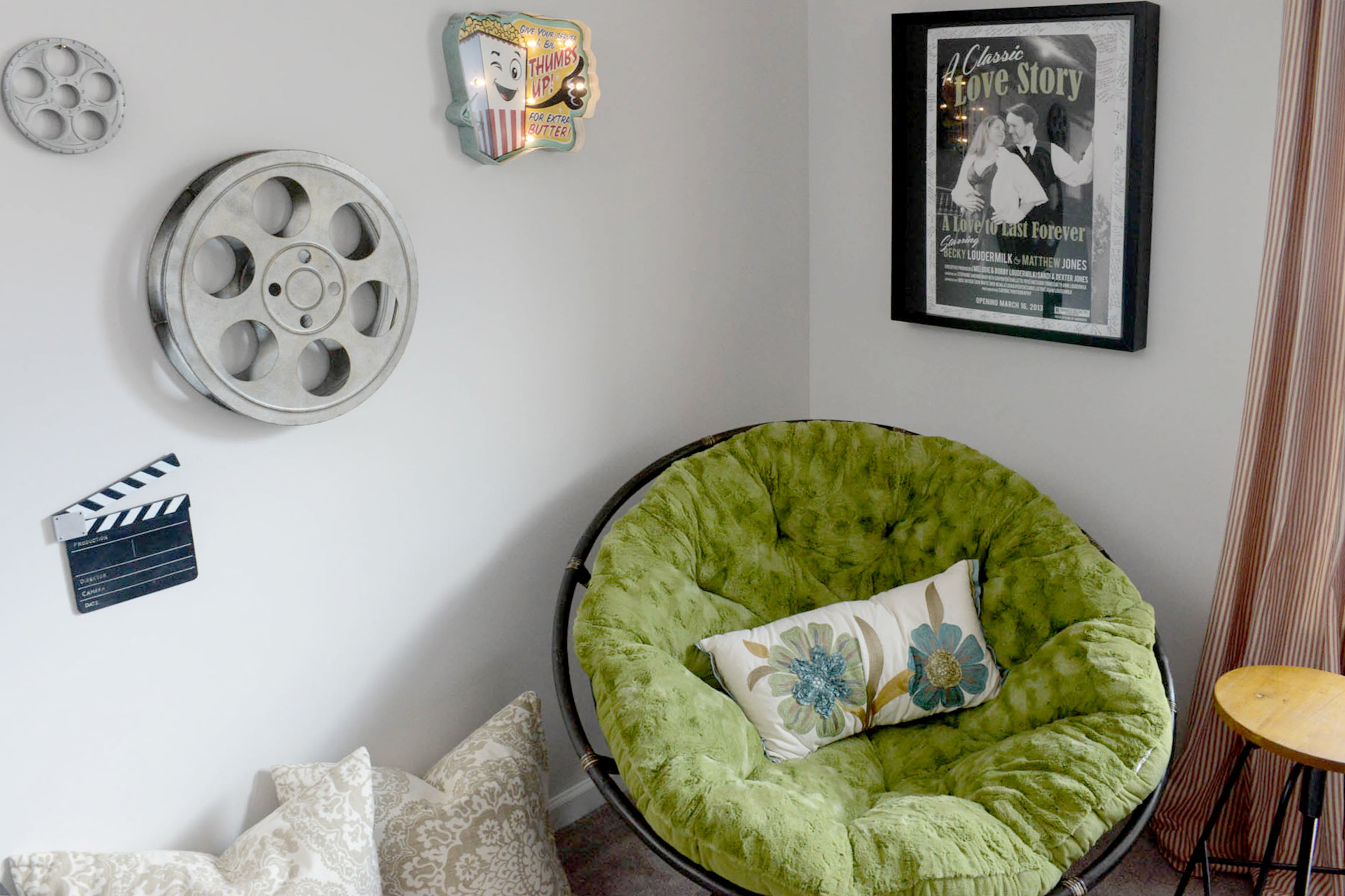 A custom movie poster hangs in the third-floor movie room. The poster, designed by artist Lauren Anita and Becky's uncle, Darrell Ezekiel, takes one of Matthew and Becky's engagement photos and transforms it into a poster for an old Hollywood movie, which was perfect for their themed wedding in 2013.