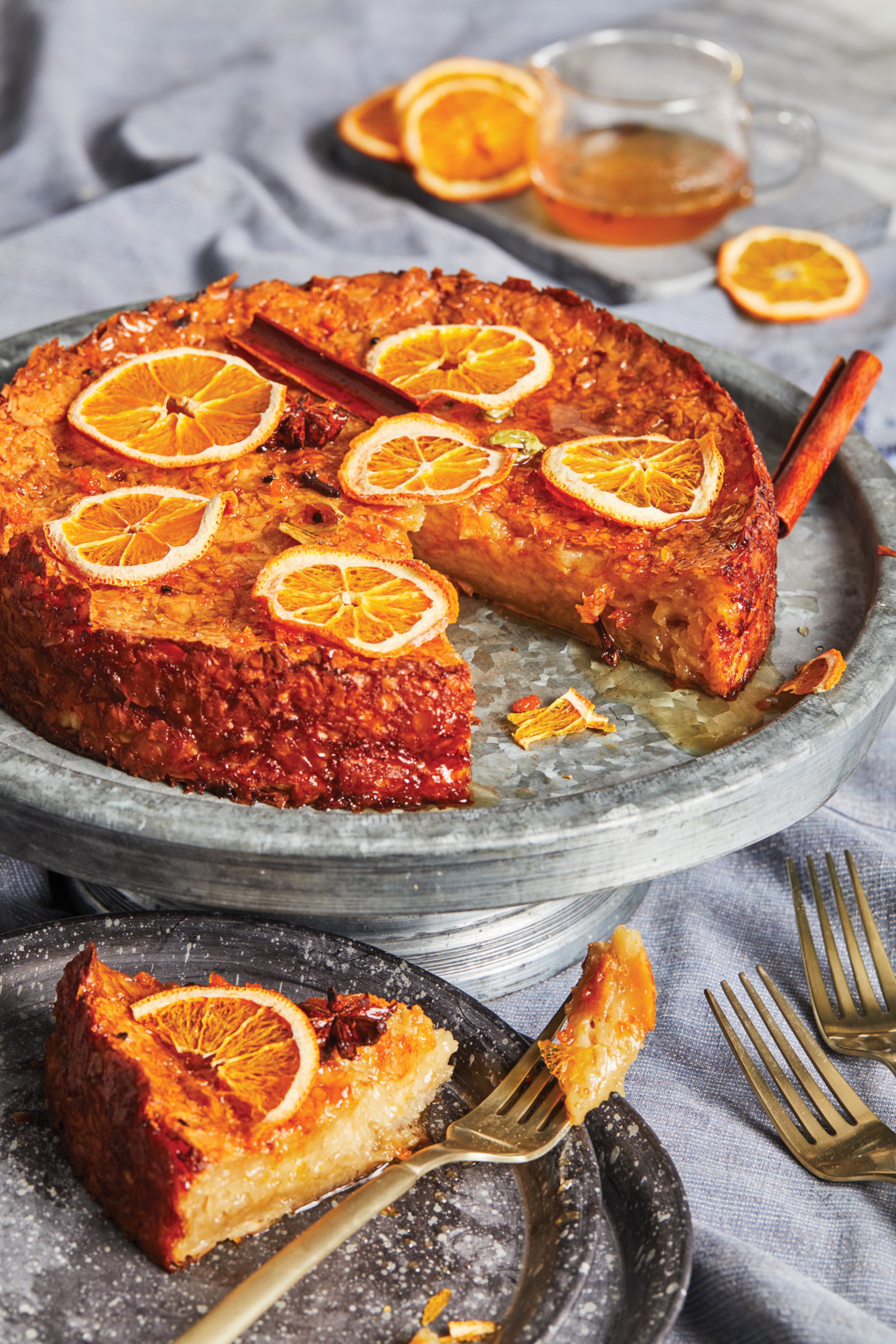 Spiced Phyllo Cake is a variation on a traditional Greek cake and is prepared with aquafaba, chickpea cooking water, instead of egg whites. The pictured caked is garnished with cinnamon sticks, dehydrated orange slices and star anise. (Courtesy of Adam Milliron)