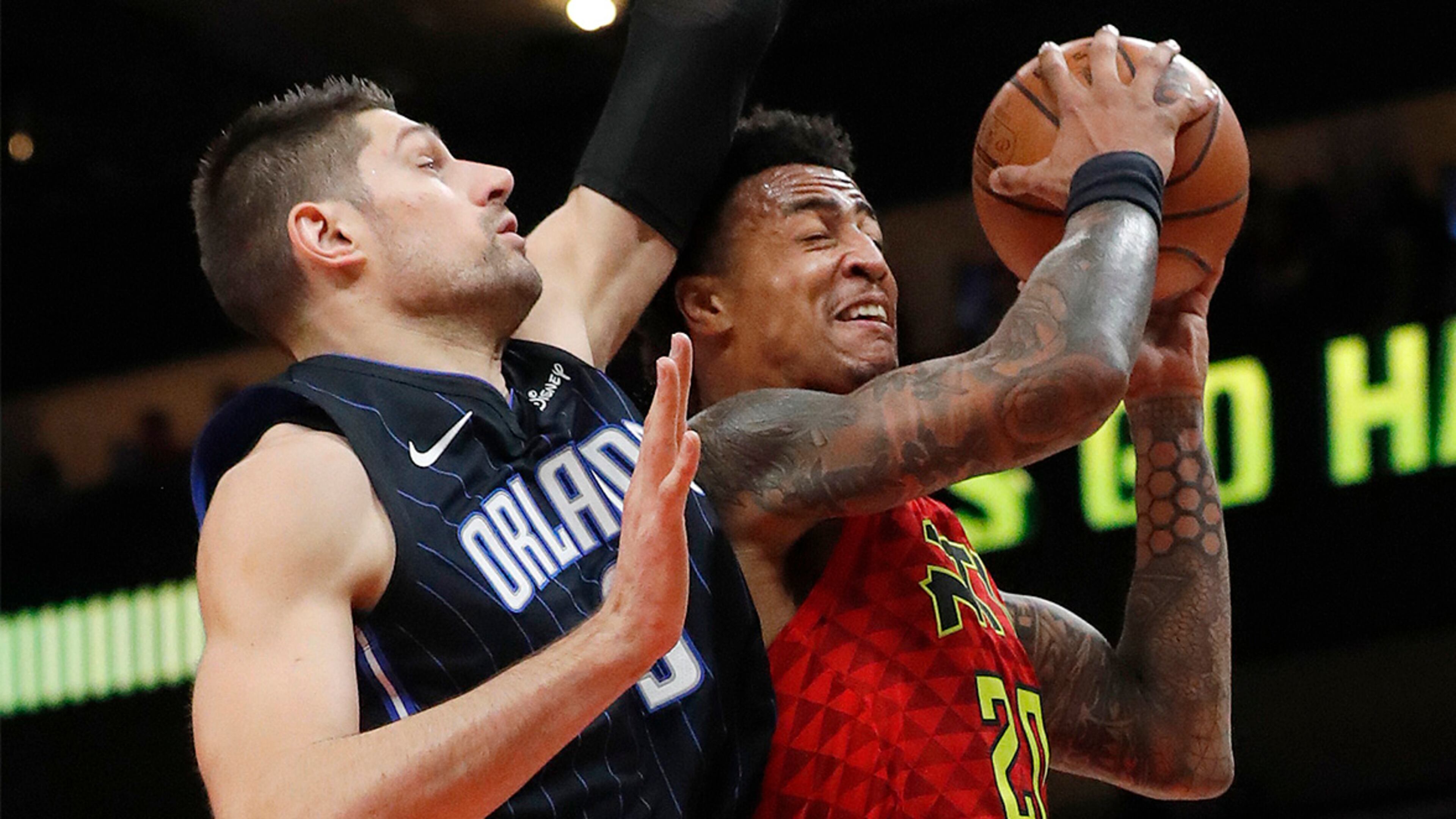 Atlanta Hawks forward John Collins goes up for a basket as Orlando Magic center Nikola Vucevic defends during the first half Sunday, Feb. 10, 2019, in Atlanta.