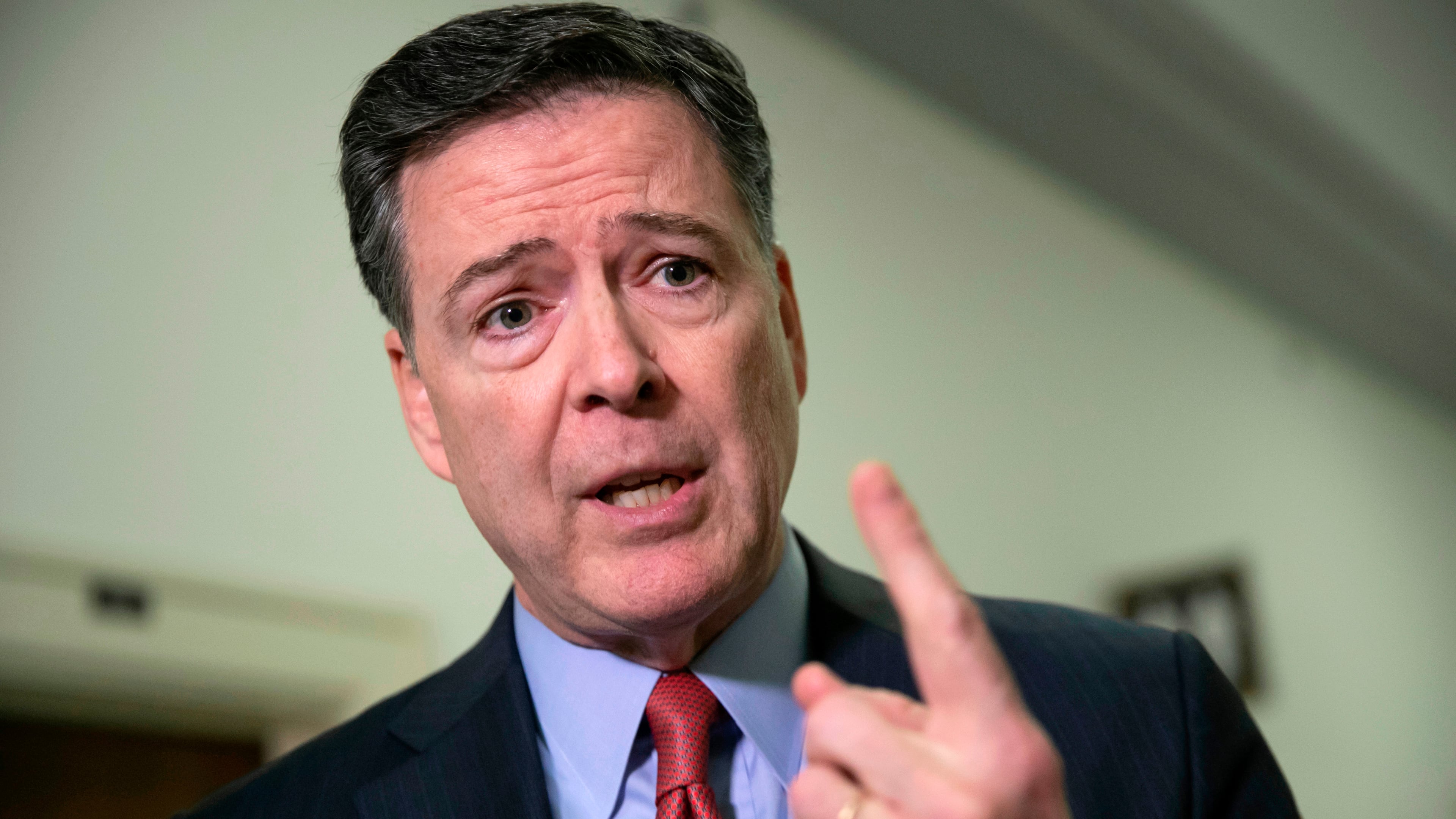 FILE - Former FBI Director James Comey speaks to reporters on Capitol Hill in Washington, Dec. 17, 2018. (AP Photo/J. Scott Applewhite, File)