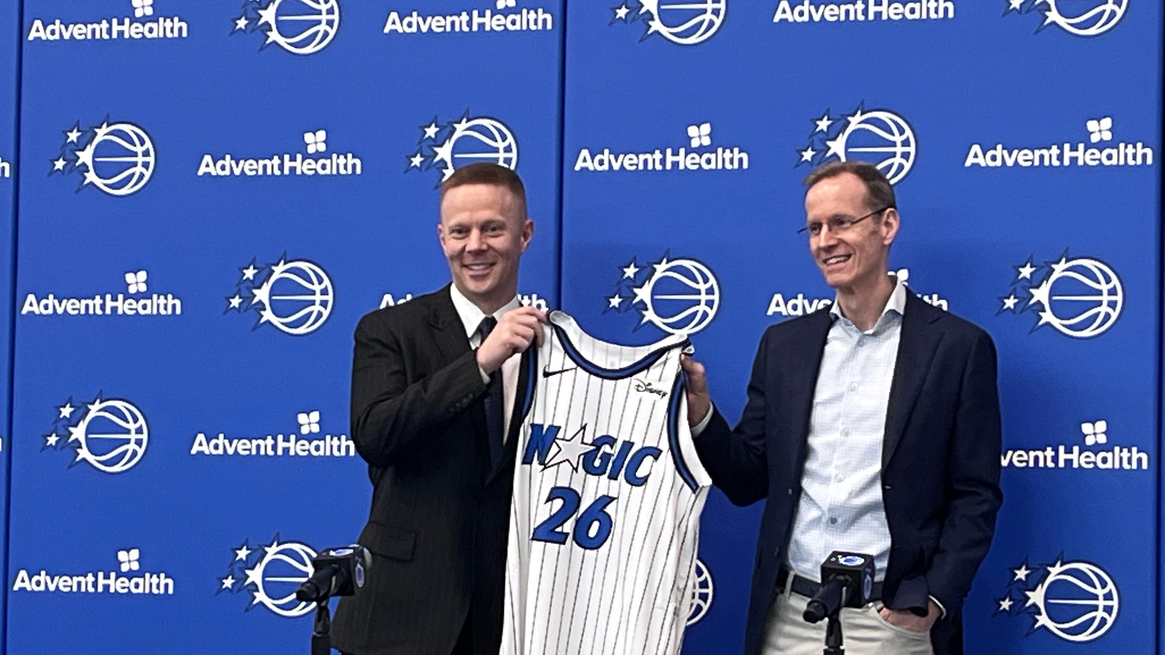 New Orlando Magic coach Sean Sweeney, left, is introduced by Magic president Jeff Weltman at a news conference at the team's training facility Thursday, June 18, 2026, in Orlando, Fla. (AP Photo/Tim Reynolds)