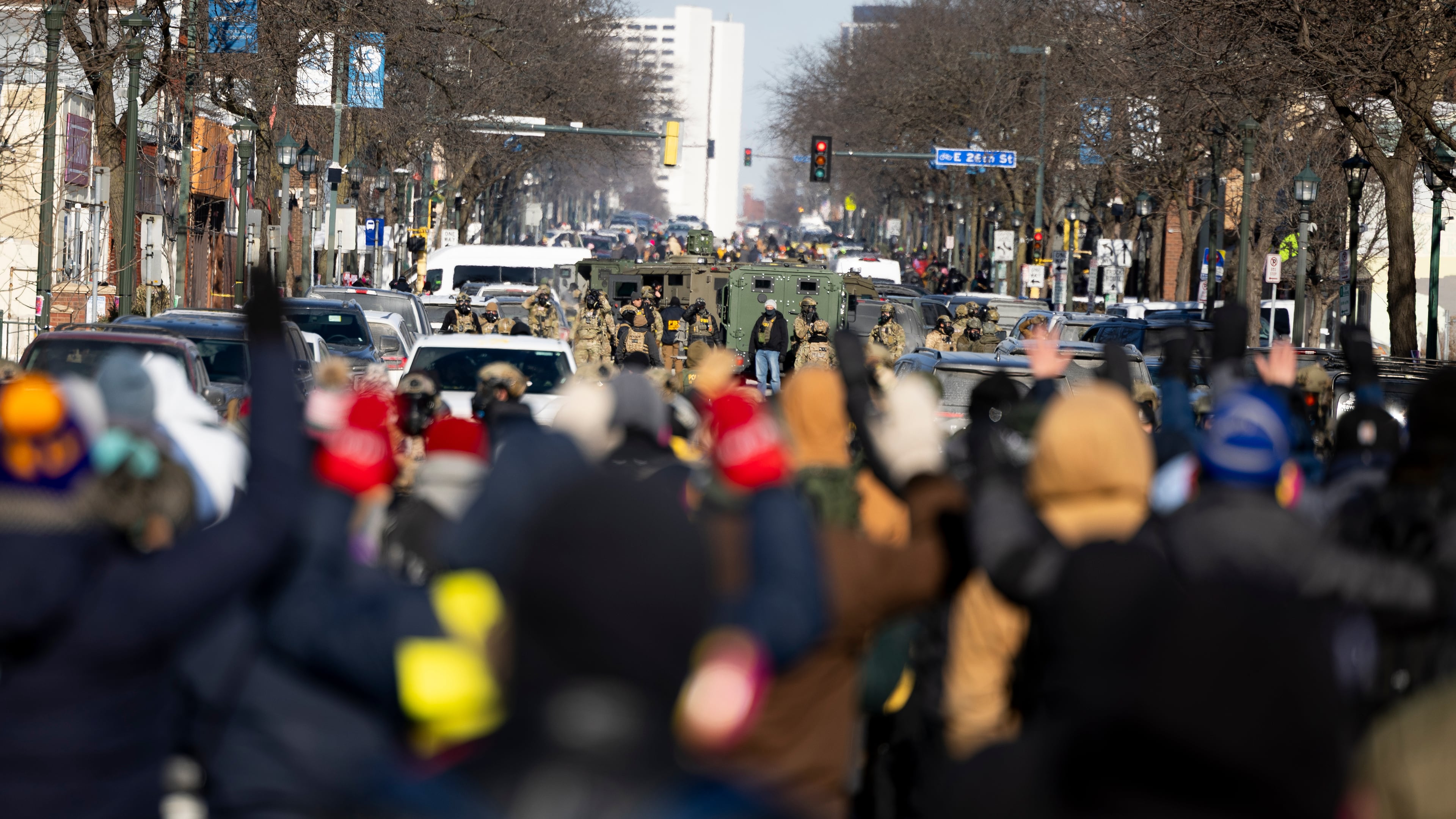 Protesters advance toward federal agents with their hands up near the site of the fatal shooting of 37-year-old Alex Pretti by federal agents in Minneapolis on Saturday, Jan. 24, 2026. (Ellen Schmidt/MinnPost via AP)