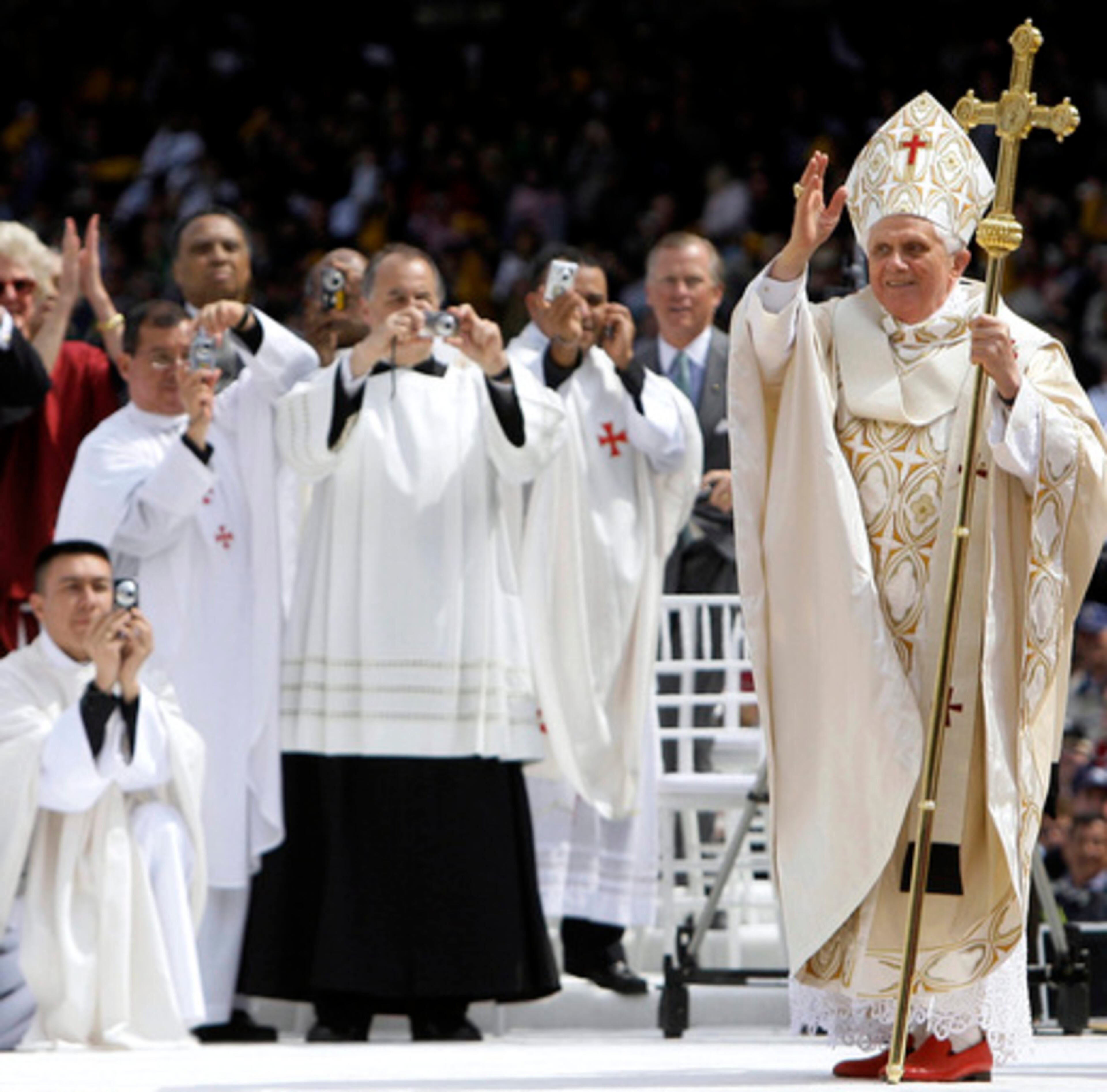 The object of many photographs over the past week during his U.S. visit, Pope Benedict XVI acknowledges the crowd as he arrives for a Sunday Mass at Yankee Stadium in New York.