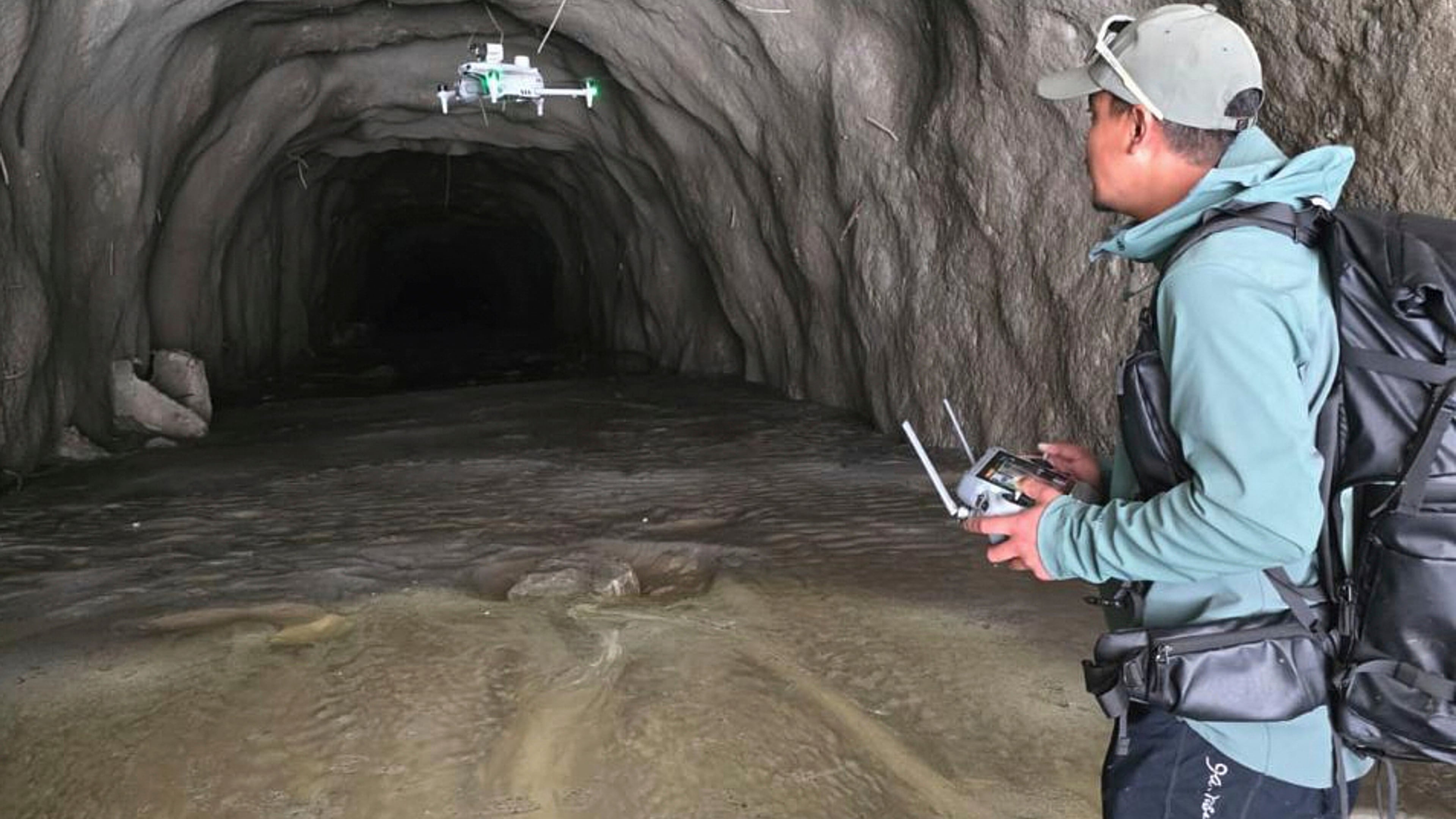 In this image provided by Manish Maharjan, filmmaker and drone pilot Manish Maharjan operates a drone at the entrance to a tunnel at the Rashuwaghadi hydropower project in Rasuwa district, Nepal, Monday, Aug. 31, 2026. (Manish Maharjan via AP)