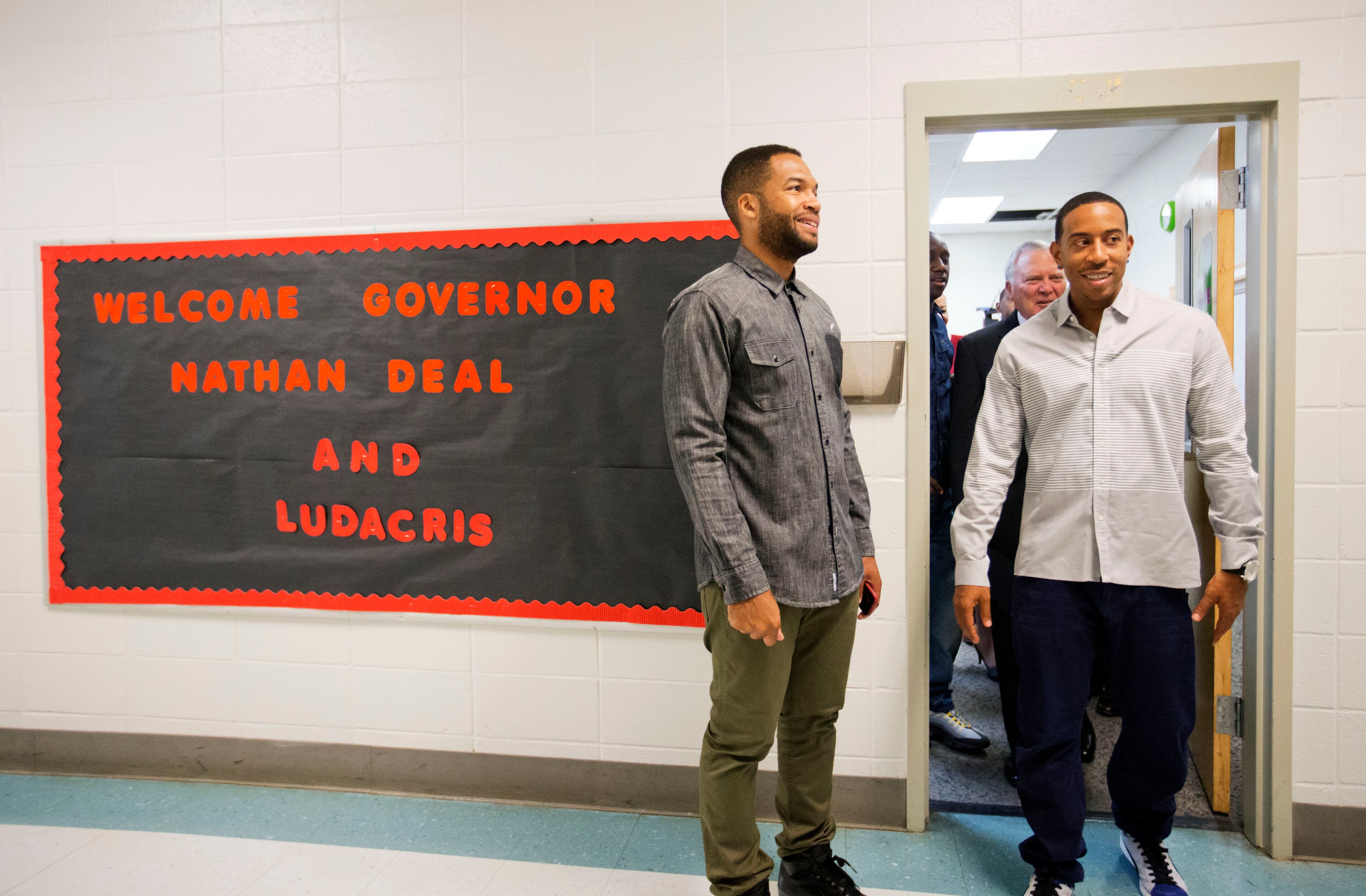 Rapper Ludacris, right, walks out of a classroom followed by Georgia Gov. Nathan Deal while visiting the charter school Utopian Academy for the Arts, Friday, Sept. 26, 2014, in Riverdale, Ga. Deal and Ludacris may seem like an odd pairing for a campaign event, but the duo was a hit with a cheering crowd of students Friday. Christopher "Ludacris" Bridges has been an outspoken supporter of President Barack Obama, penning a profane song during the 2008 campaign criticizing his opponents. But Deal says he couldn't think of anyone better to inspire students at the event. (AP Photo/David Goldman)