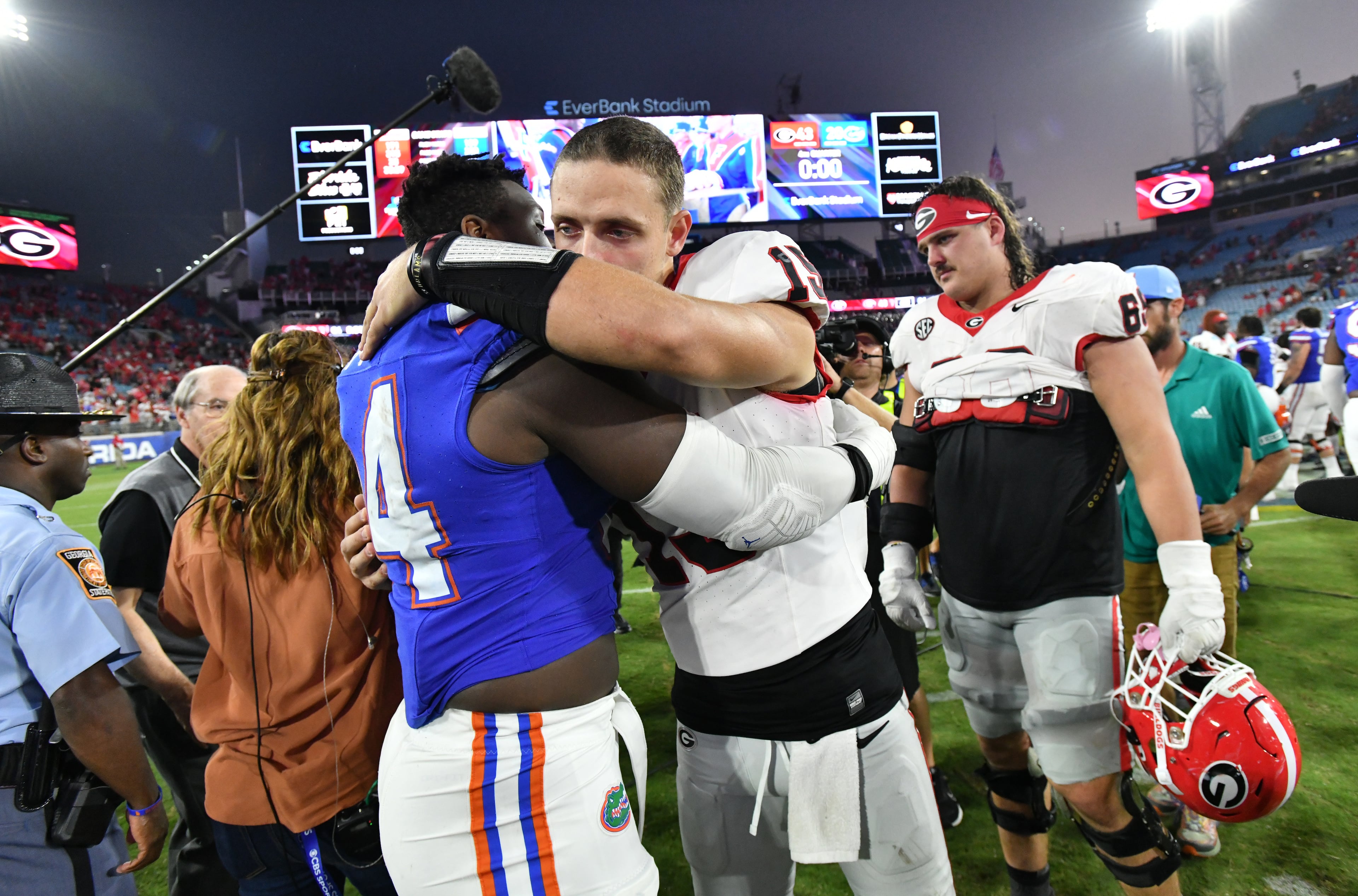 Georgia quarterback Carson Beck (15) hugs Florida defensive lineman Tyreak Sapp (94) after Georgia beat Florida during an NCAA football game at EverBank Stadium, Saturday, October 28, 2023, in Jacksonville, FL. Georgia won 43-20 over Florida. (Hyosub Shin / Hyosub.Shin@ajc.com)
