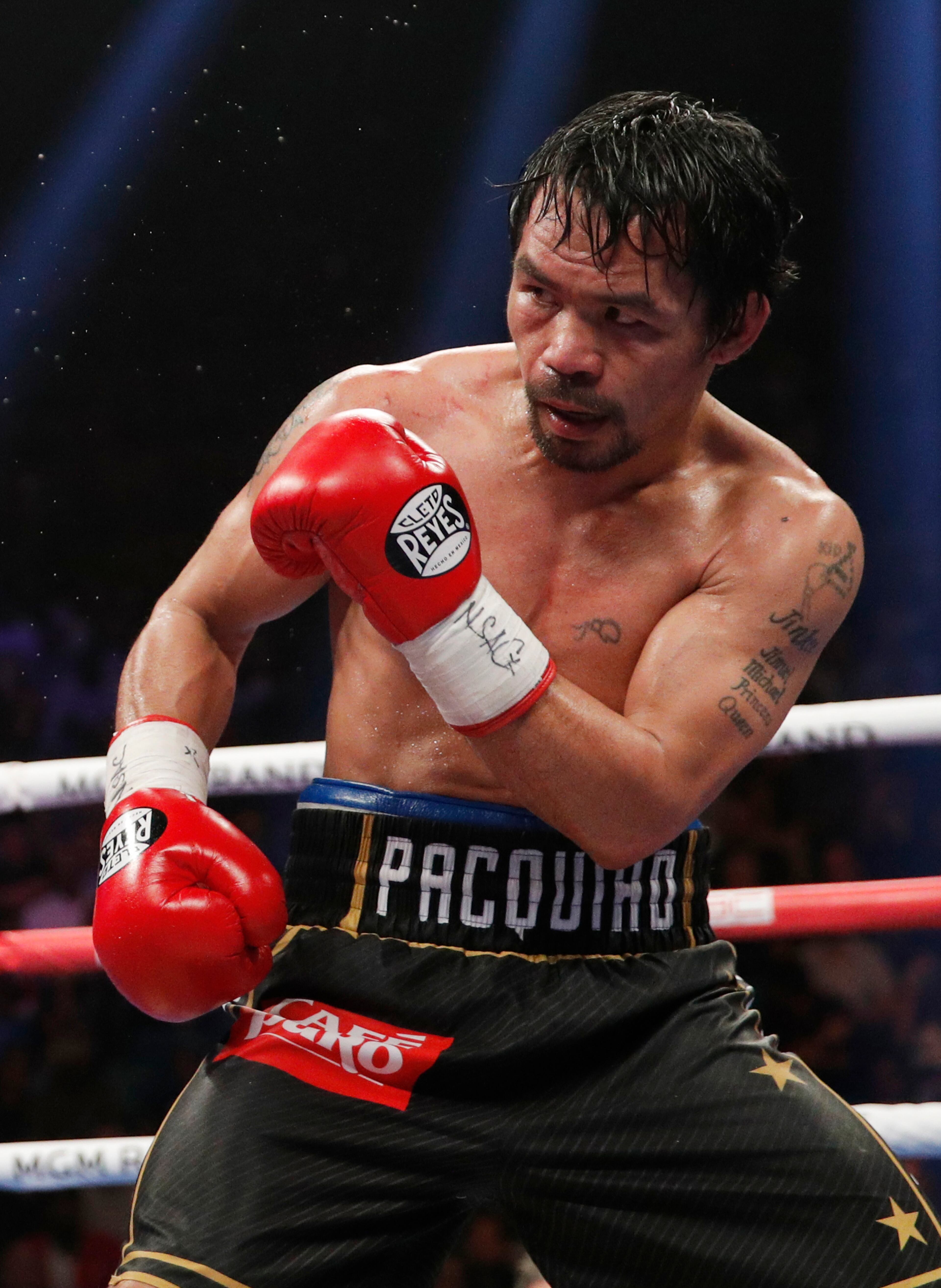 Manny Pacquiao fights Adrien Broner, not pictured, in a welterweight championship boxing match Saturday, Jan. 19, 2019, in Las Vegas. (AP Photo/John Locher)