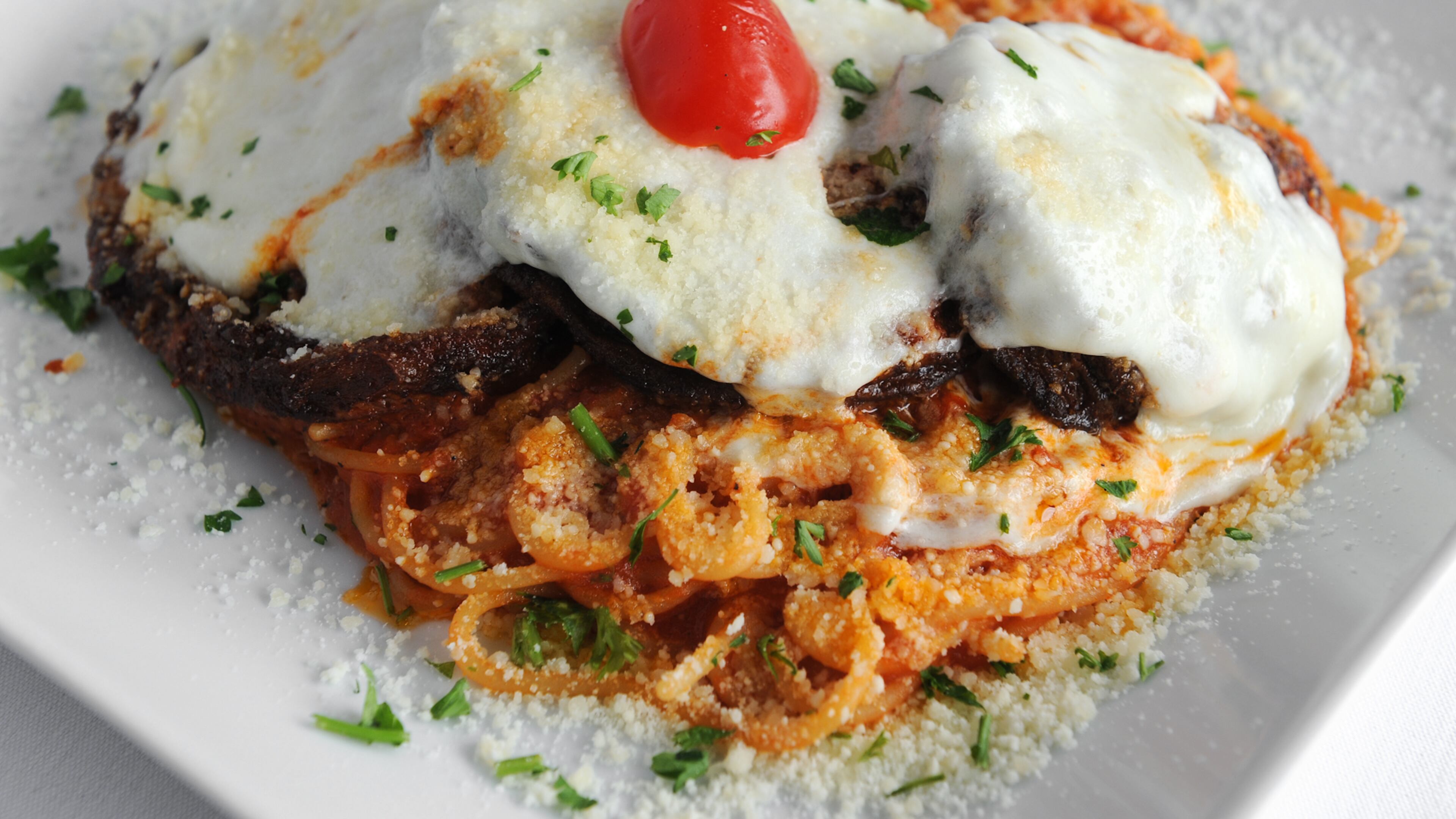 La Parmigiana- eggplant served with spaghetti and marinara sauce at Mezza Luna (BECKY STEIN PHOTOGRAPHY)