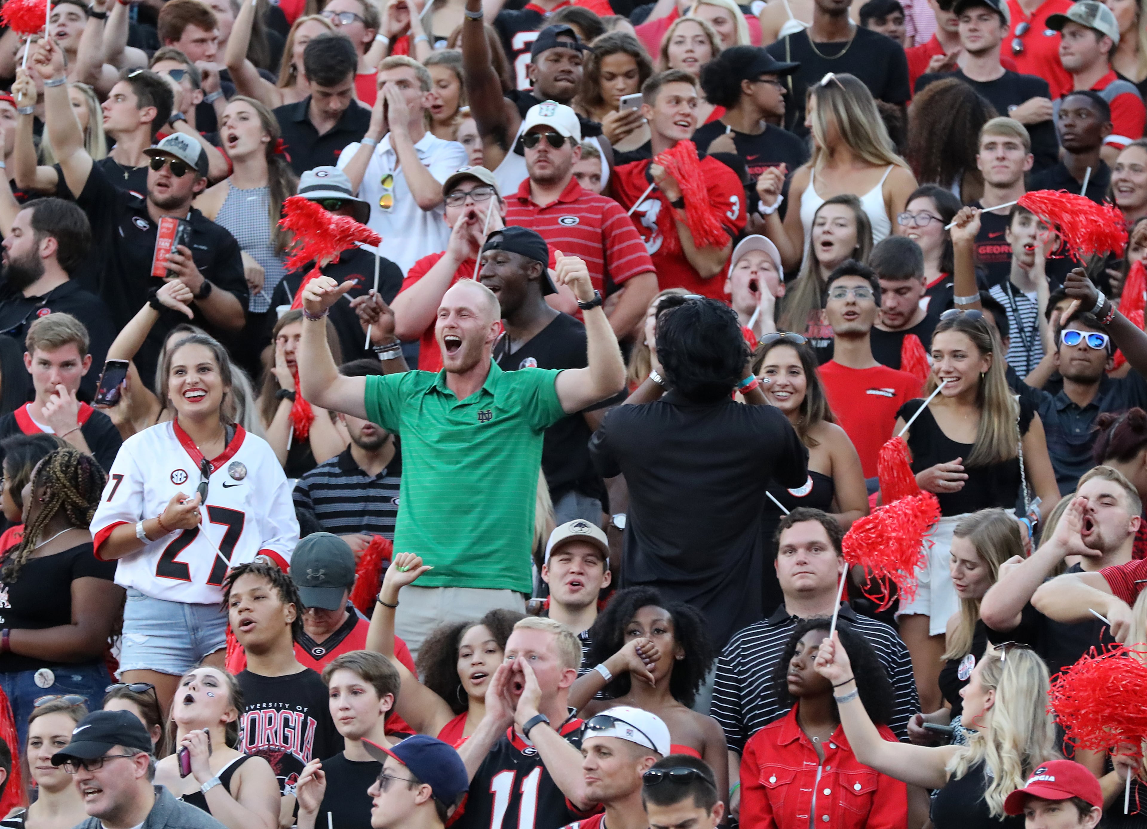 A Notre Dame fan finds himself surrounded by Georgia fans. Curtis Compton/ccompton@ajc.com