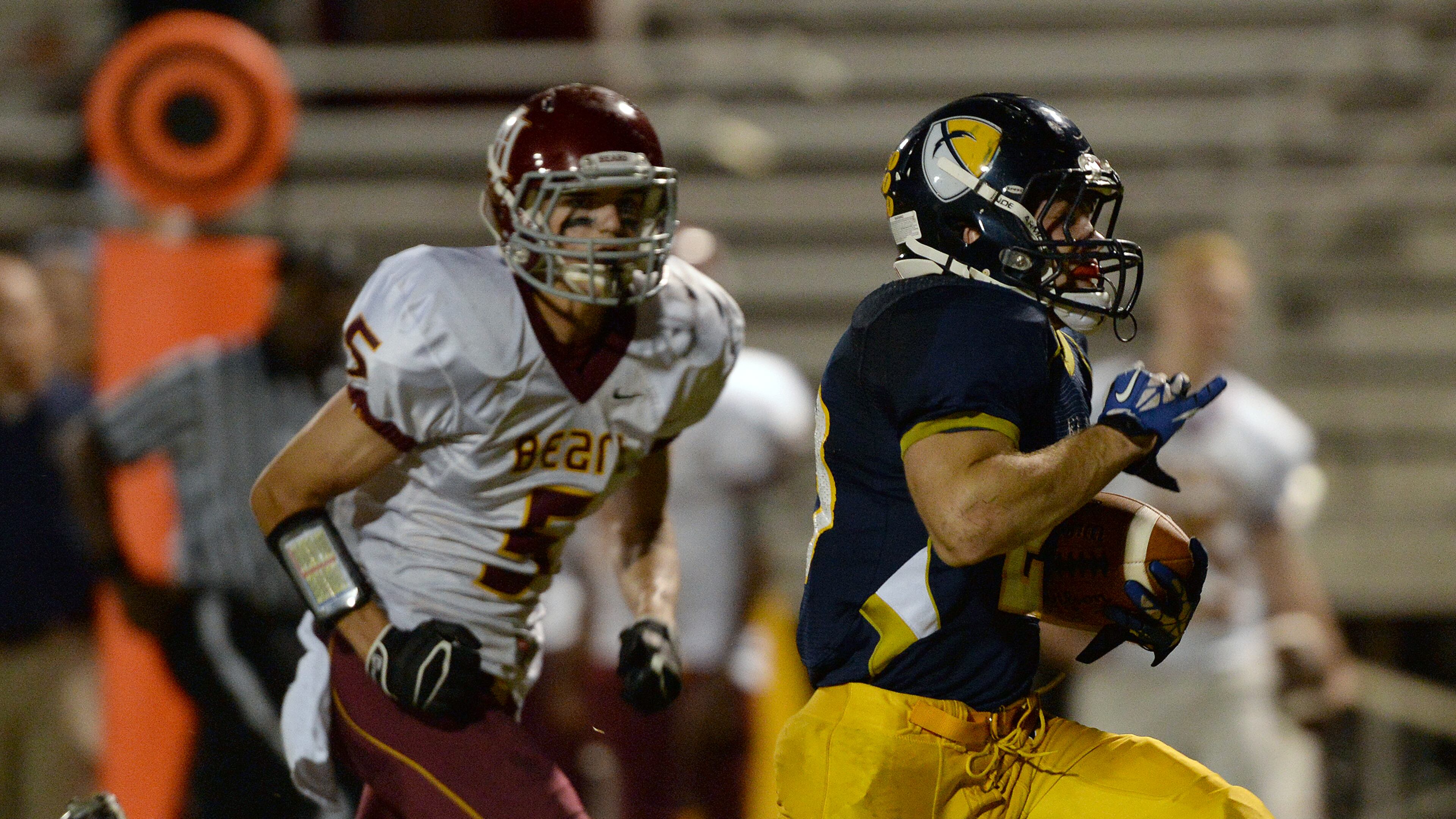 Holy Innocents' Thomas Walker (5) chases Eagle's Landing Christian Academy's Lane Timpson (20) as he runs for a touchdown at Eagle's Landing Christian Academy on Friday, September 27, 2013.