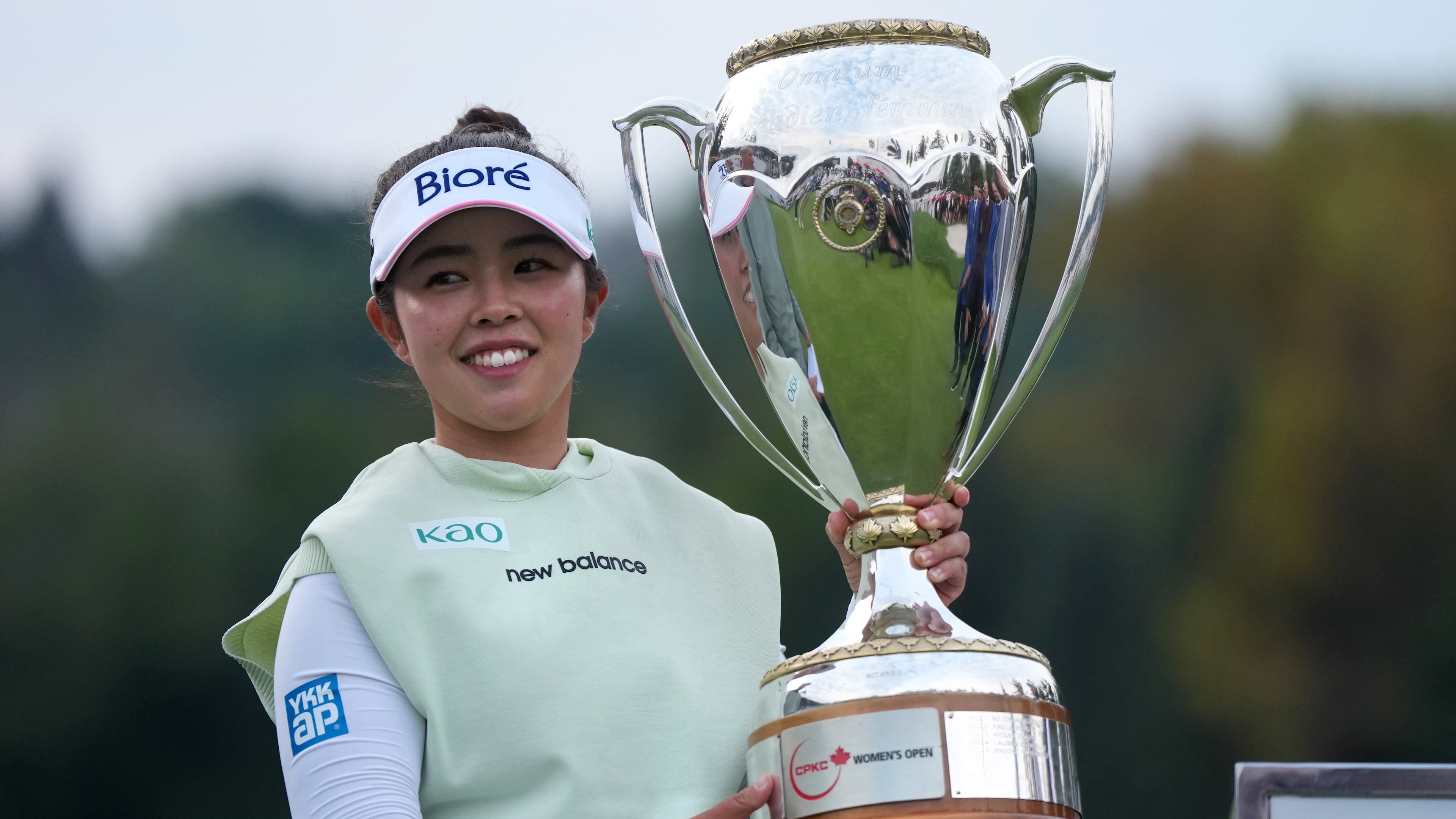 Miyu Yamashita, of Japan, celebrates with the trophy after winning the LPGA Canadian Women's Open golf tournament in Edmonton, Alberta, Sunday, Aug. 23, 2026. (Darryl Dyck/The Canadian Press via AP)