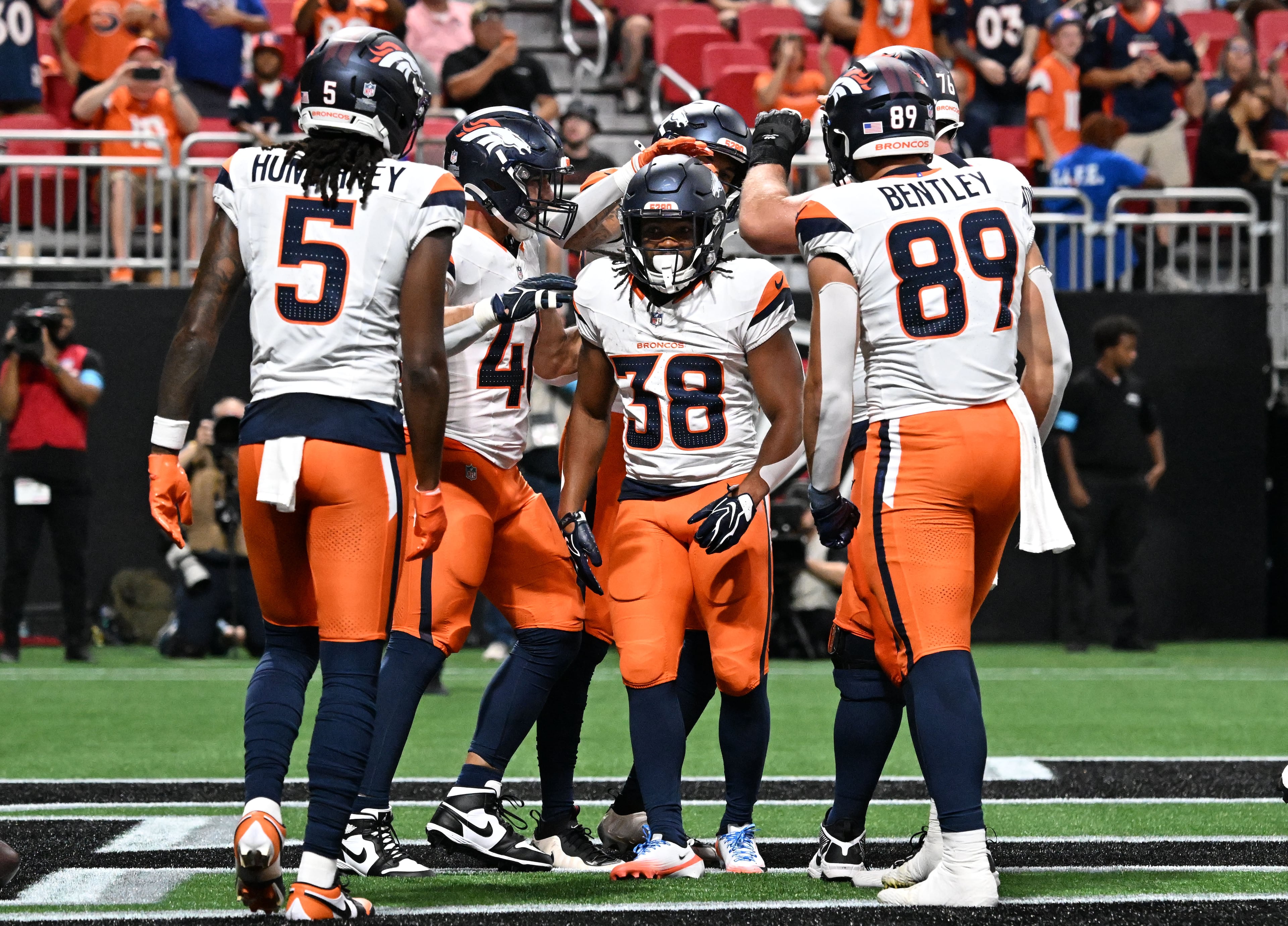 Broncos running back Jaleel McLaughlin (center) celebrates with teammates after scoring a touchdown during their preseason game against the Falcons at Mercedes-Benz Stadium on Friday, Aug. 14, 2026, in Atlanta. (Hyosub Shin/AJC)